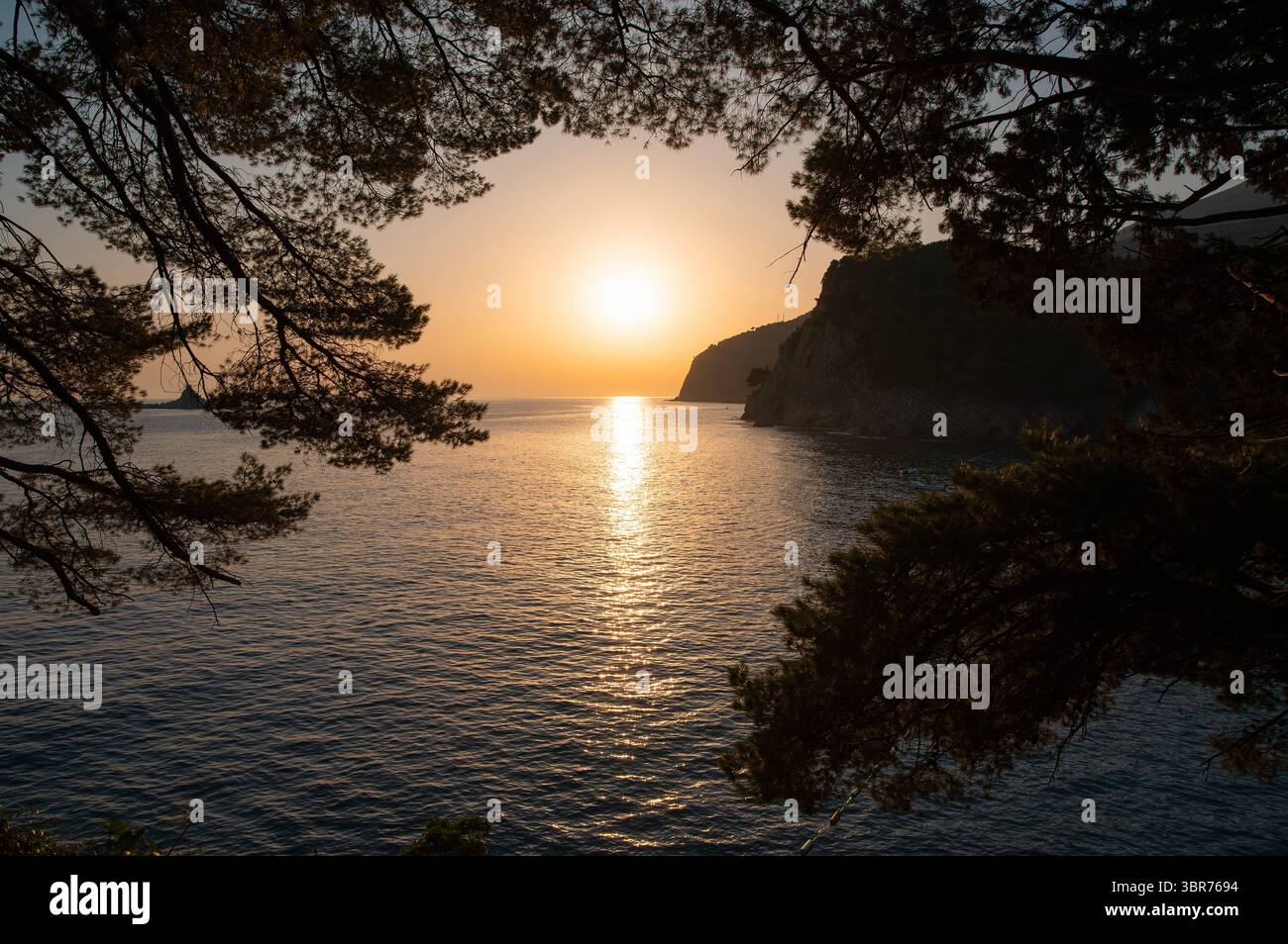 Serene Sunset Over Calm Sea Stock Photo