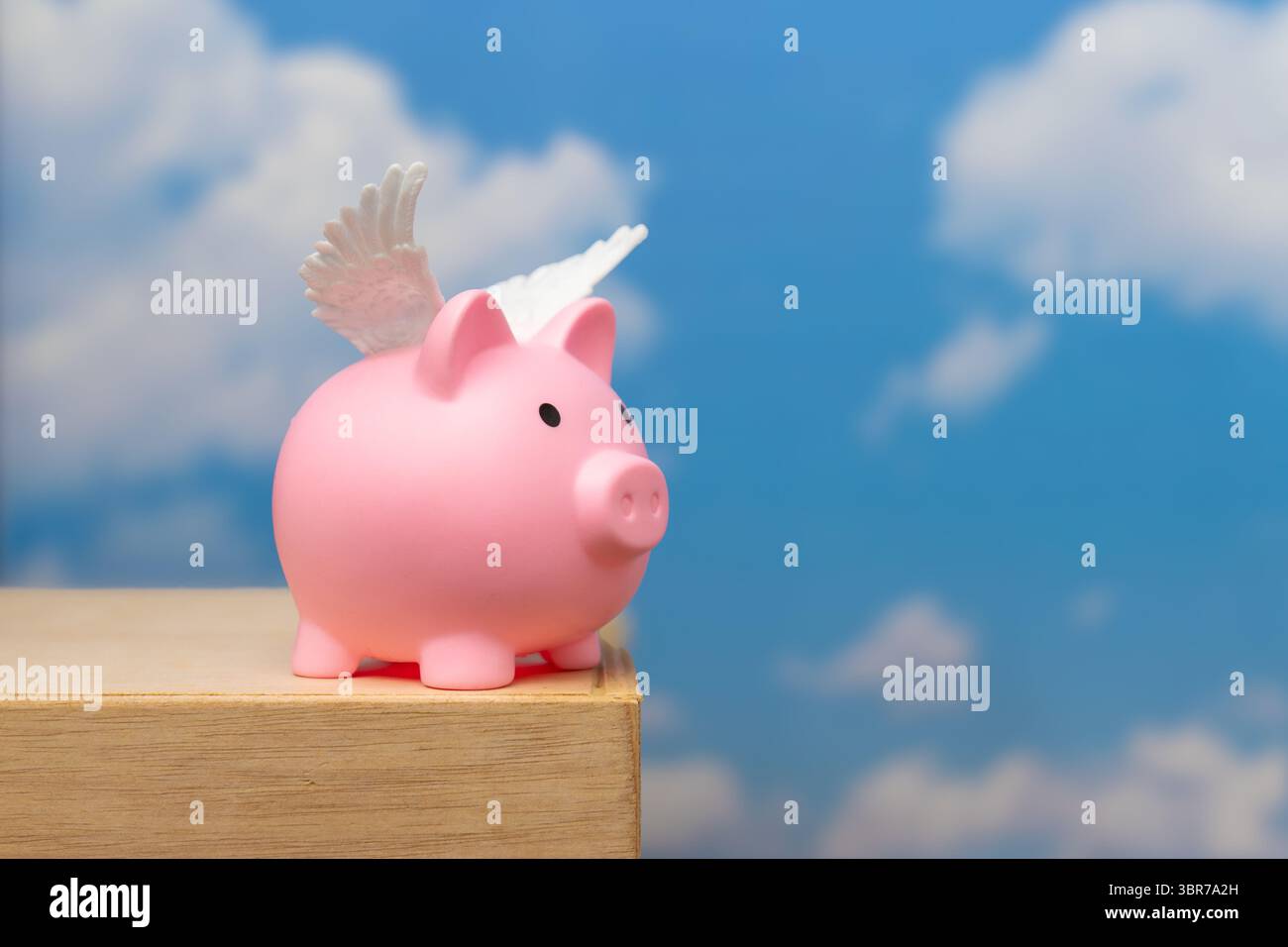 A pink pig with small white wings. Represents the idiom "when pigs fly," signifying something highly improbable or impossible. Stock Photo