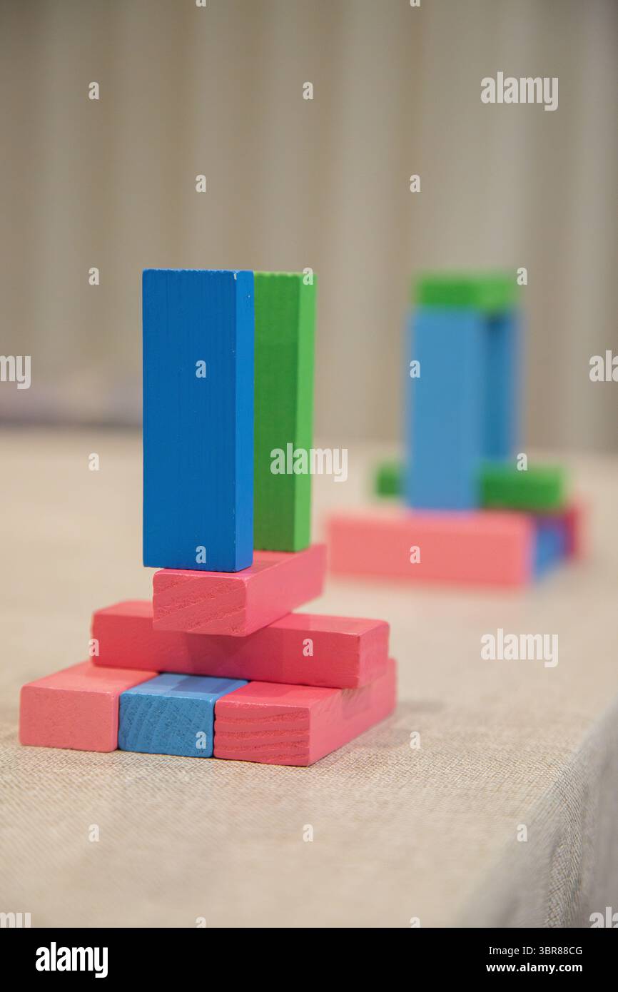 Colorful wooden blocks stacked on a surface. Playful objects to help ...
