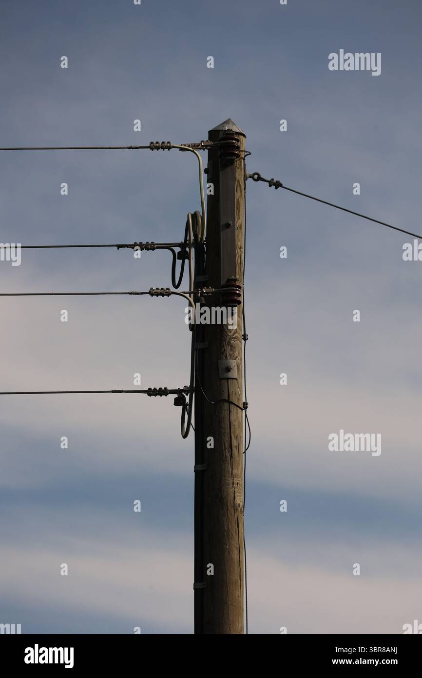 A tall wooden pole with wires on it Stock Photo - Alamy
