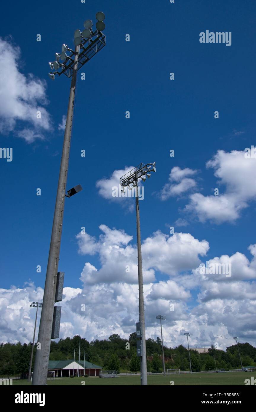 Field lighting poles against a blue sky Stock Photo