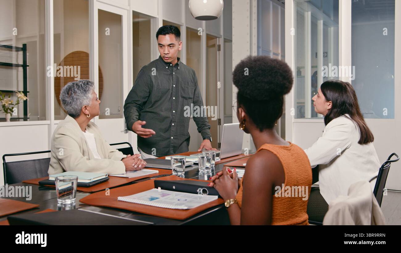 Team Collaborating in a Modern Office Setting During a Meeting Stock Photo