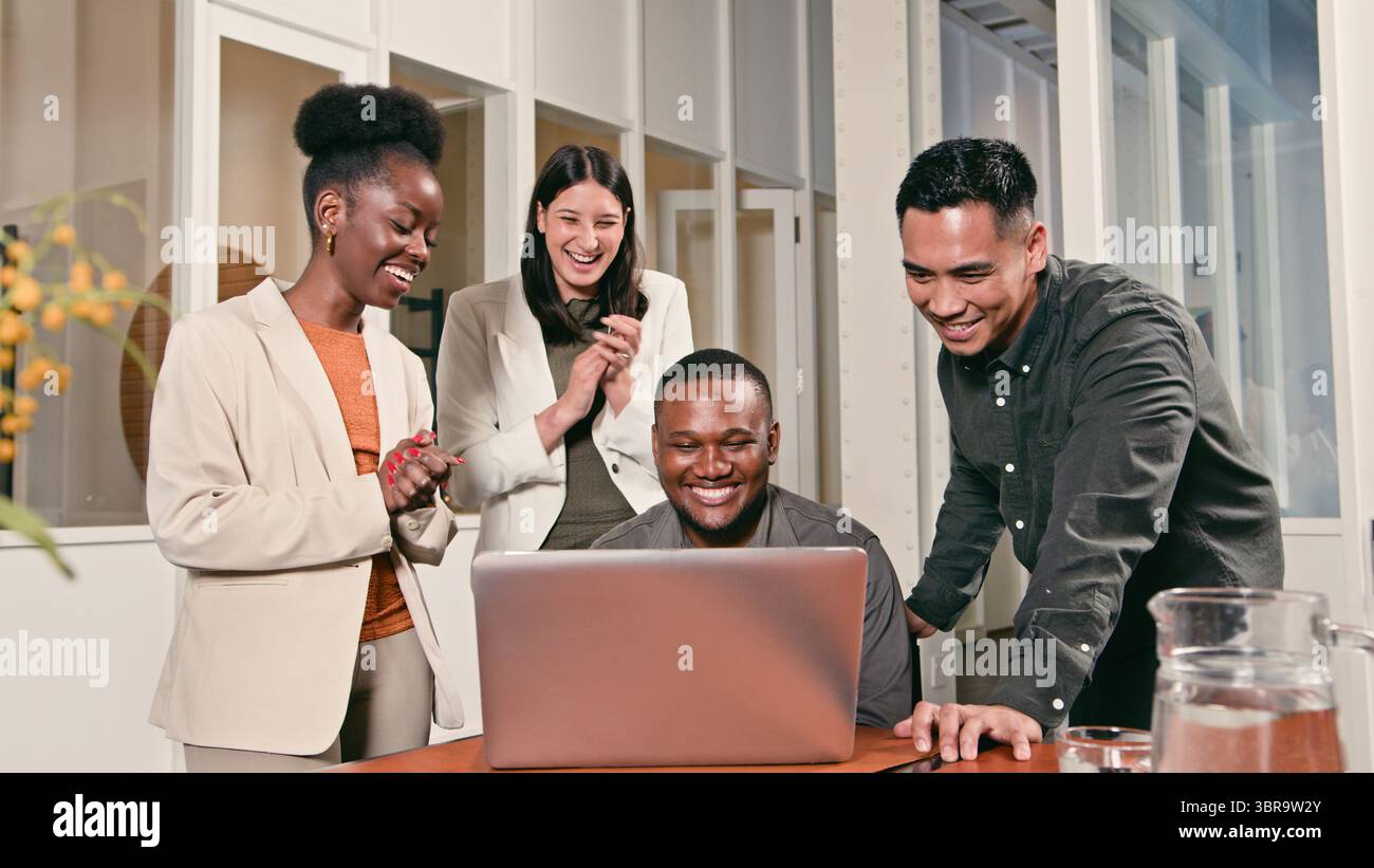 Diverse Team Collaborating in a Modern Office on a Successful Project Stock Photo