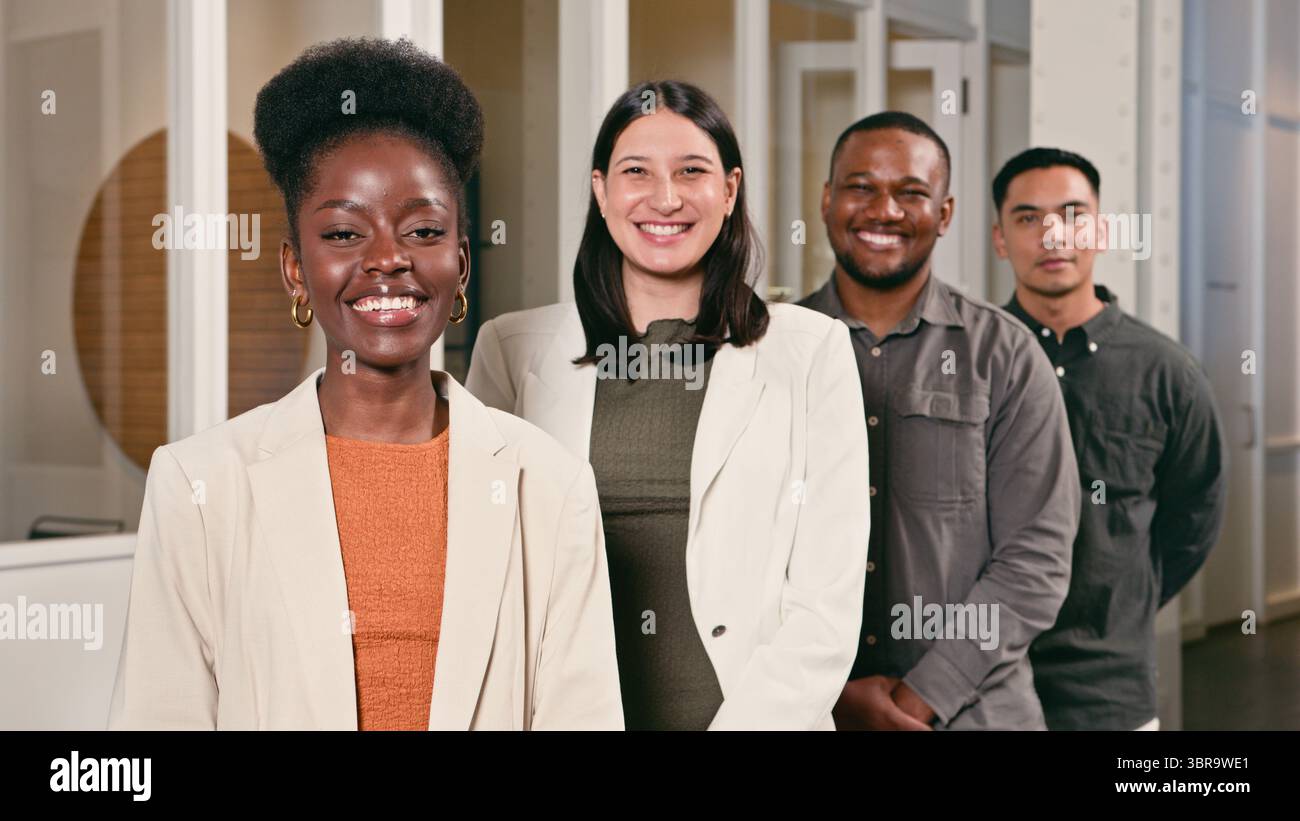 Diverse Professional Team Smiling Confidently in Modern Office Setting Stock Photo