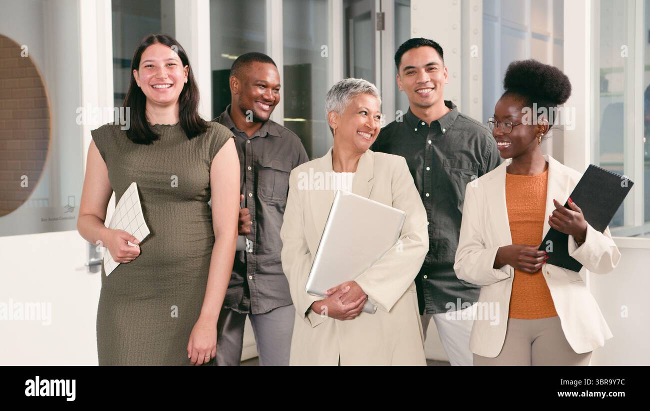 Diverse Group of Professionals Smiling and Interacting in a Modern Office Setting Stock Photo