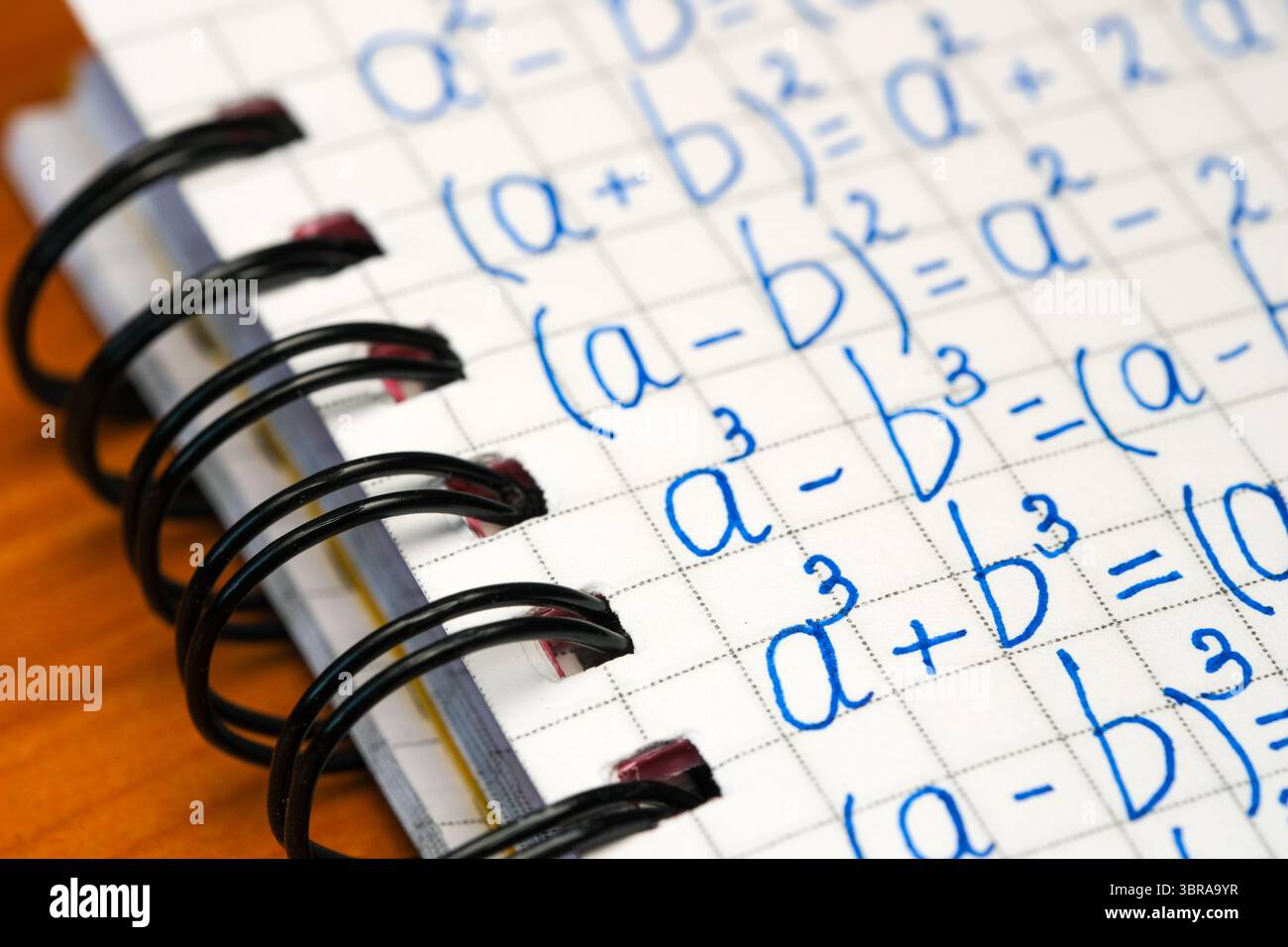 Mathematics concepts illustrated on a notebook filled with meticulous calculations. Stock Photo