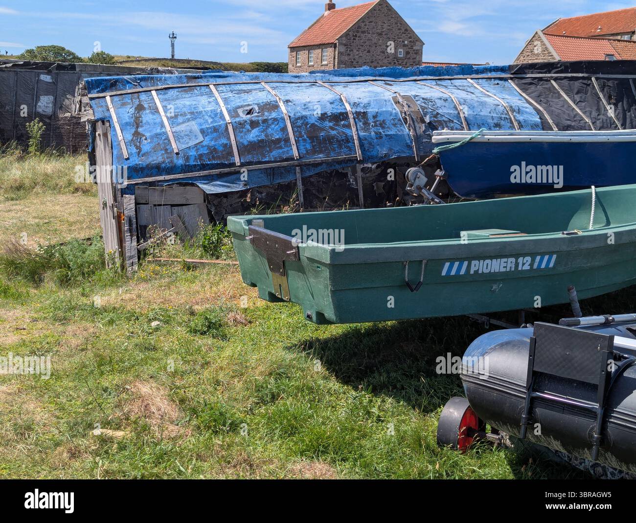 Rustic beauty on Holy Island: The distinctive wooden fishing shacks of Lindisfarne offer a glimpse into the island's timeless character and coastline. - Smartphone Captured Stock Image
