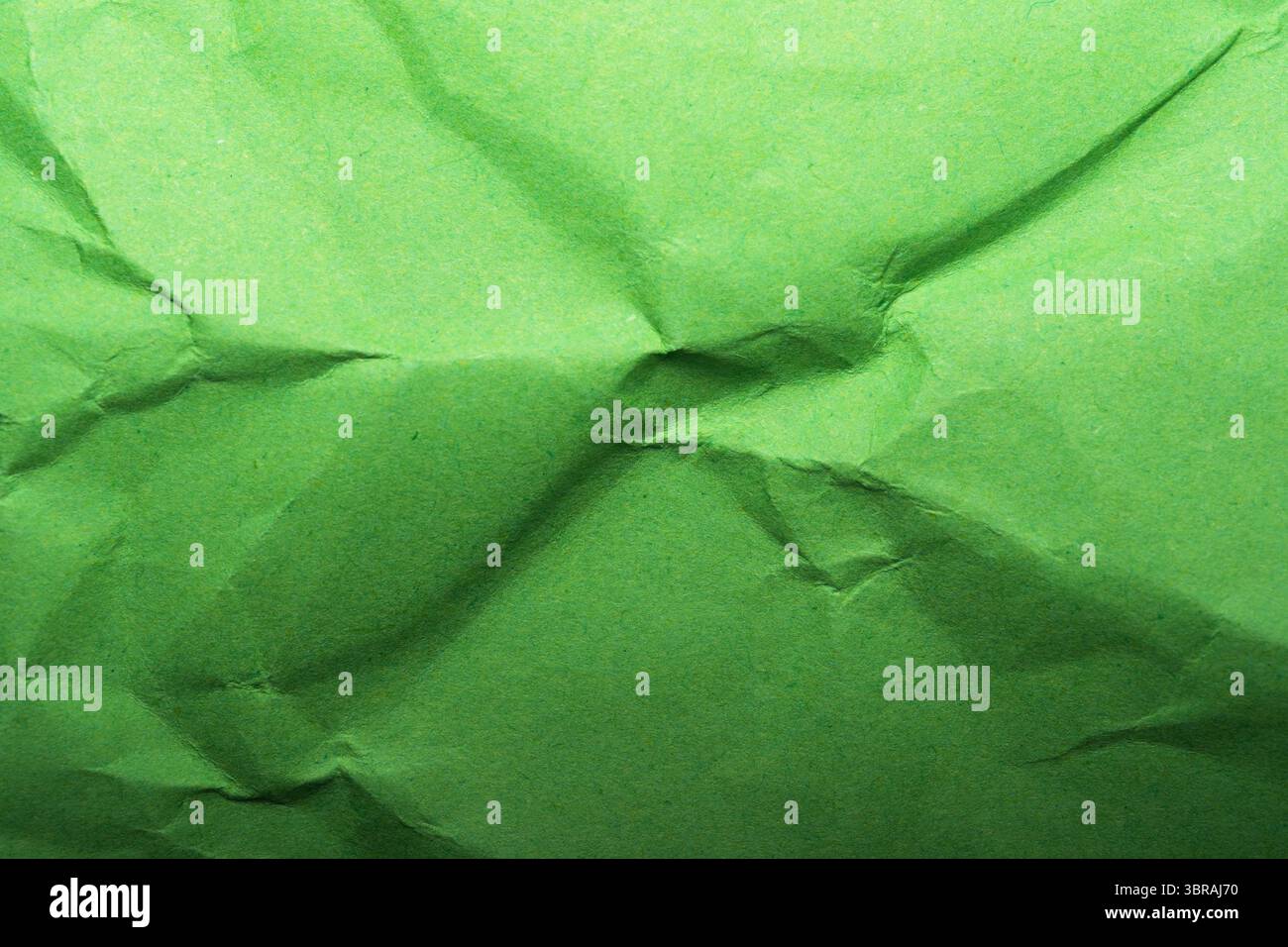 A vibrant, crumpled green surface invites tactile exploration and creativity. Stock Photo