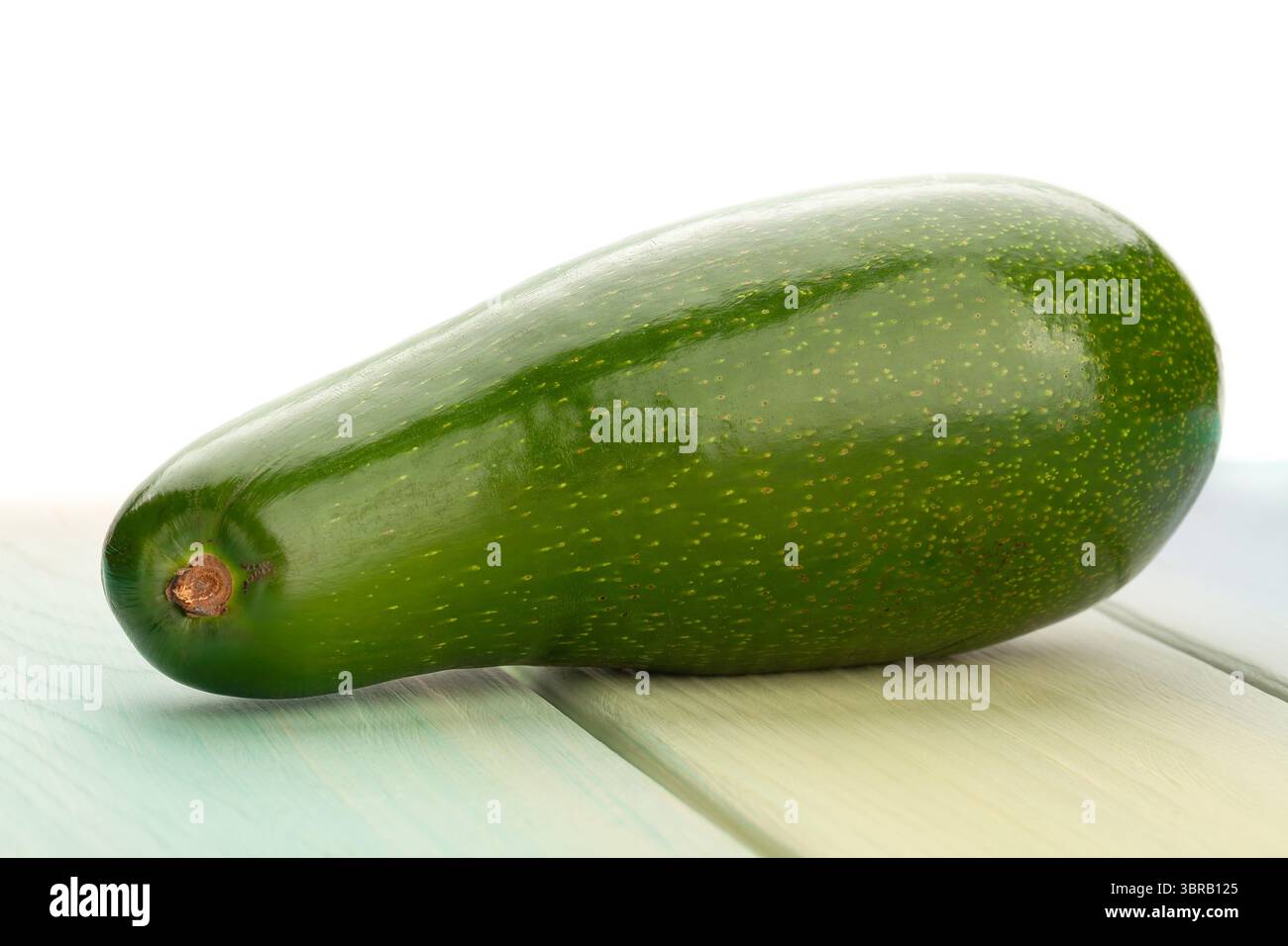 avocado on wood background on white Stock Photo