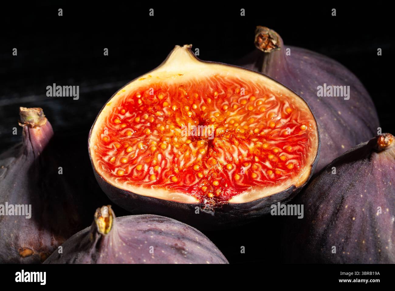 sliced figs fruit on black background top view Stock Photo