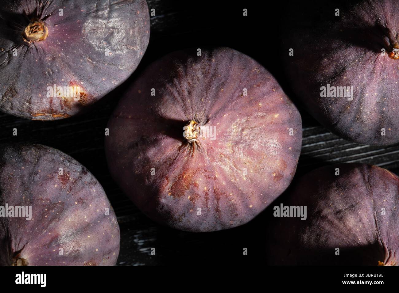figs fruit on black wood background top view Stock Photo