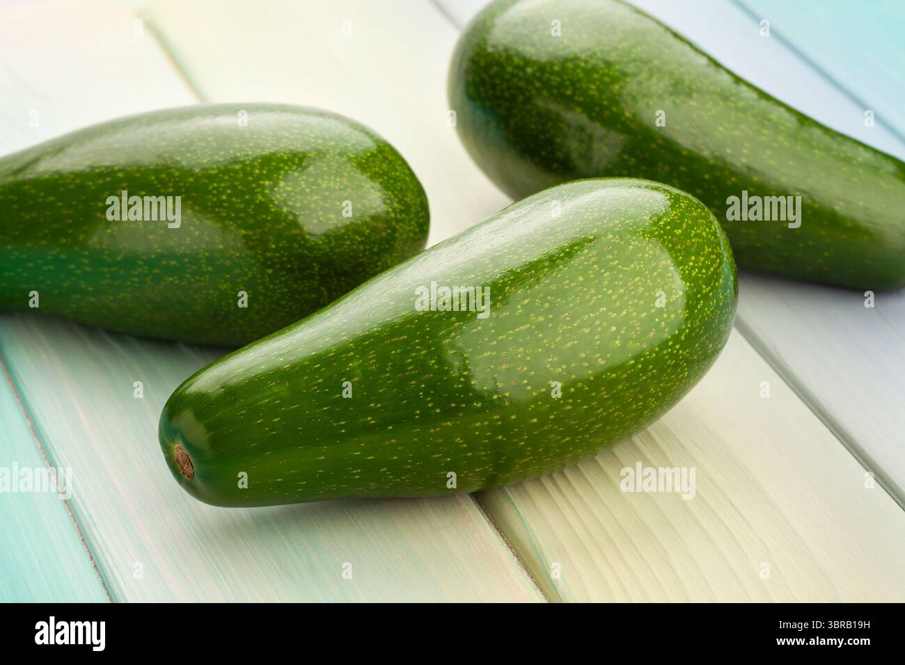 avocado on blue wood background Stock Photo
