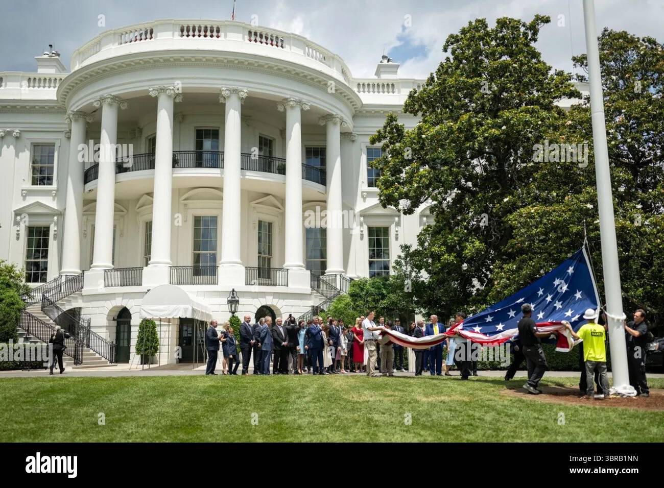 President Donald Trump gestures during the raising of a new American ...