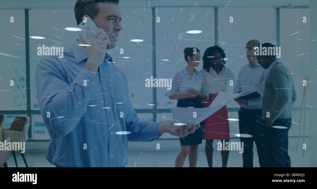 Man talking on smartphone, holding document in office, with binder, stack of papers, copy space Stock Photo