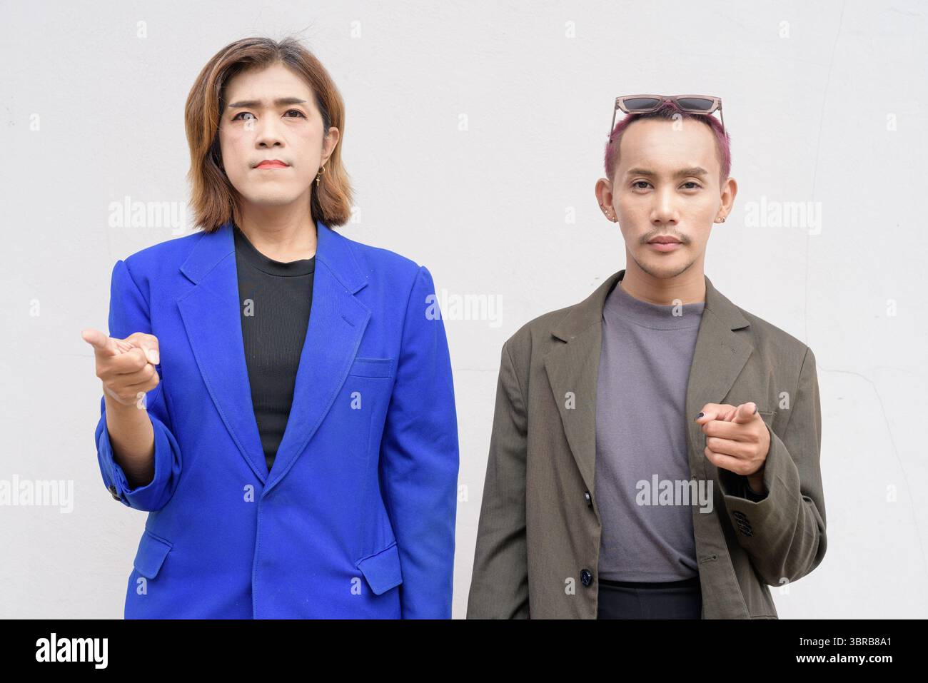 Gender inclusive Asian business team couple against white background Stock Photo