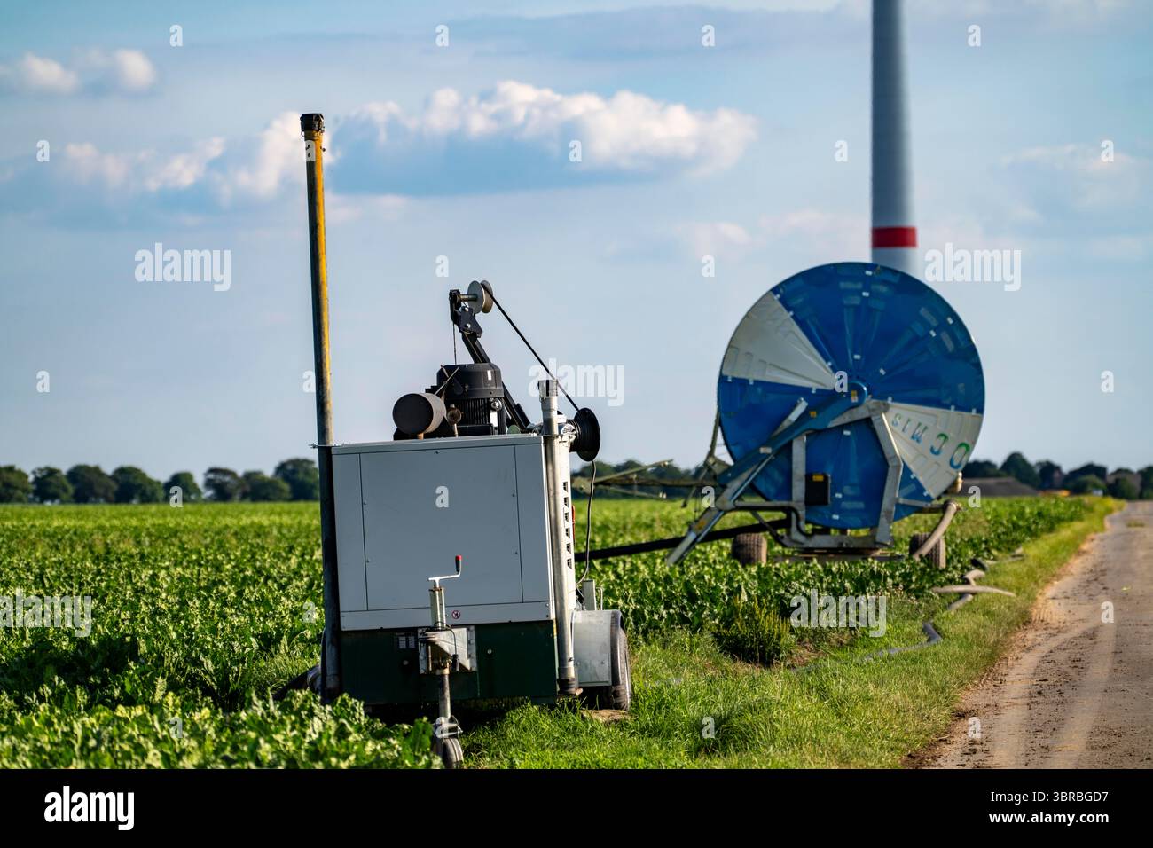 Mobile pump for artificial irrigation with a sprinkler system on a field where sugar beets are grown. The water is pumped from a well east of Kerken, Stock Photo