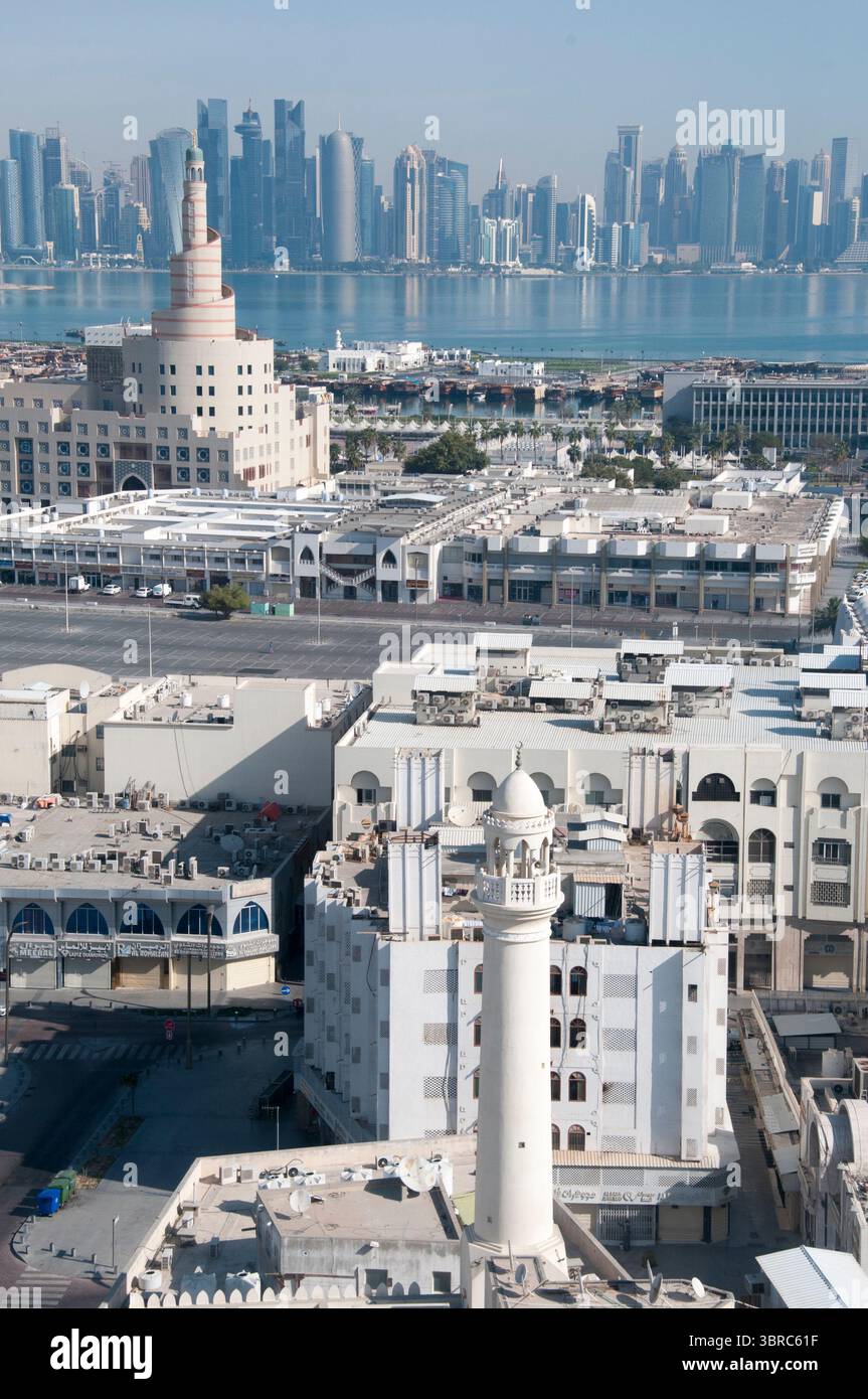 Spiral minaret of the Fanar Islamic Cultural Centre, with The Pearl Island beyond. Doha, Qatar Stock Photo