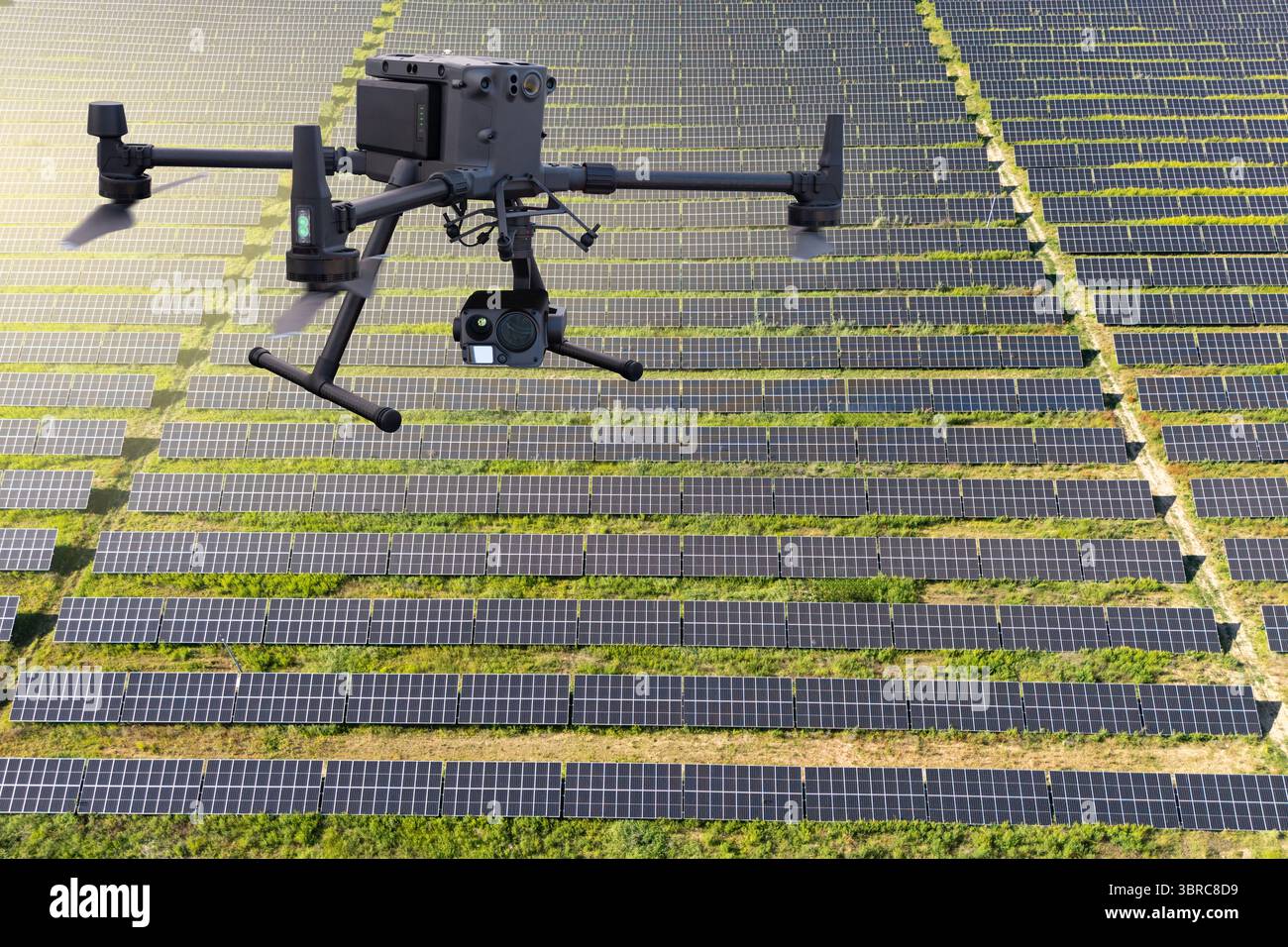 Industrial drone inspects solar panels Stock Photo