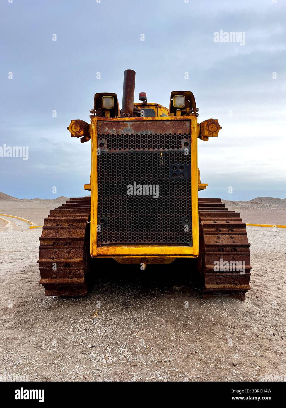 Front view of Large old rusty mining vehicle out of work standing for exhibition on the coast of Peru in San Juan de Marcona Stock Photo
