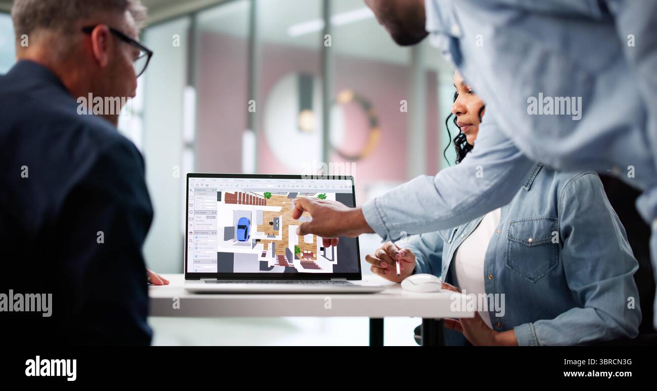 Multiracial Design Team Using CAD Software To Remodel Real Estate. Stock Photo