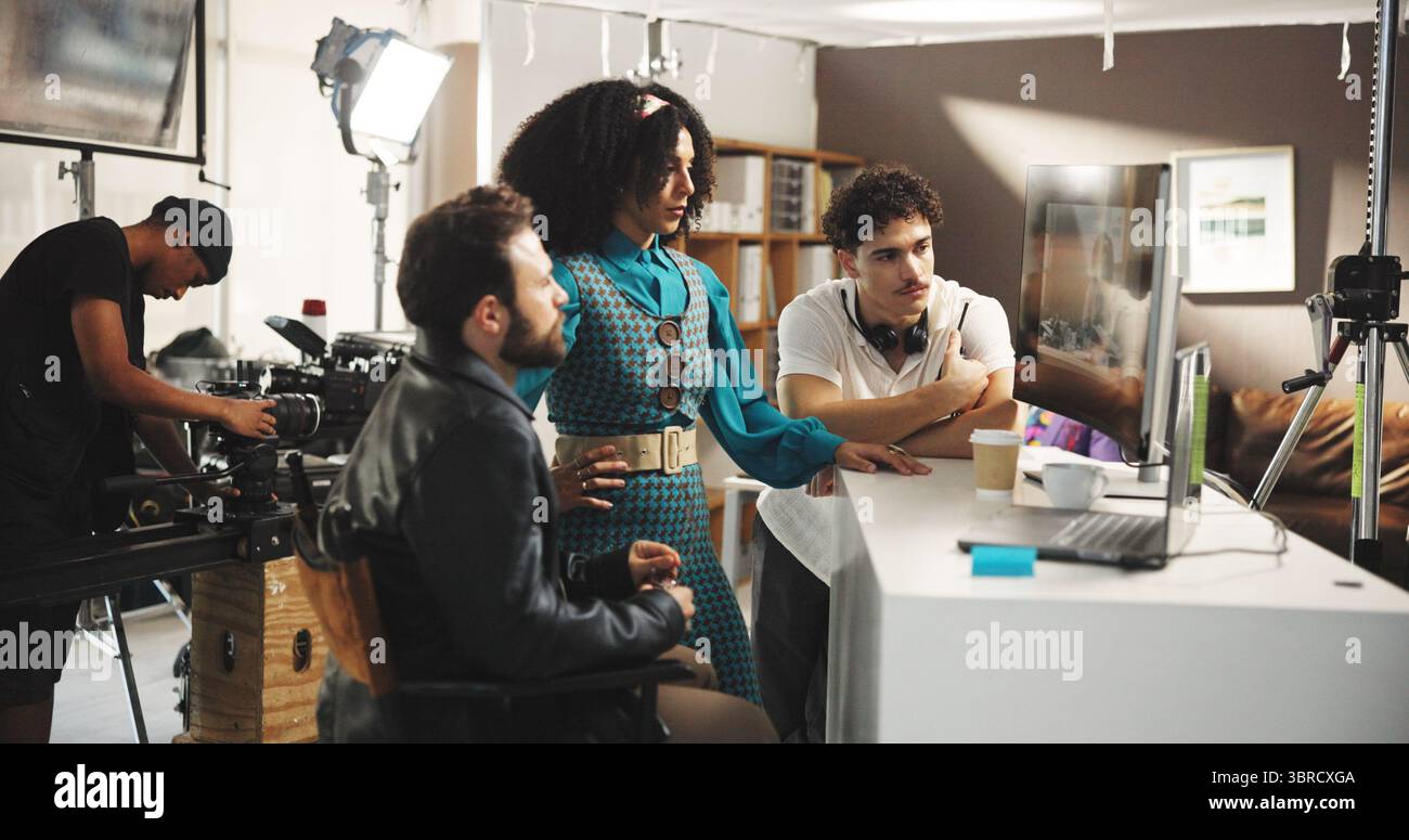 People, director or watching playback with monitor for crew performance, review or retake in studio. Producer, actress and assistant with recording Stock Photo