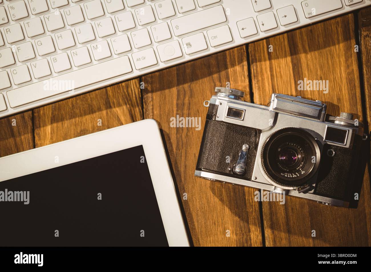 Keyboard camera and tablet on desk Stock Photo - Alamy
