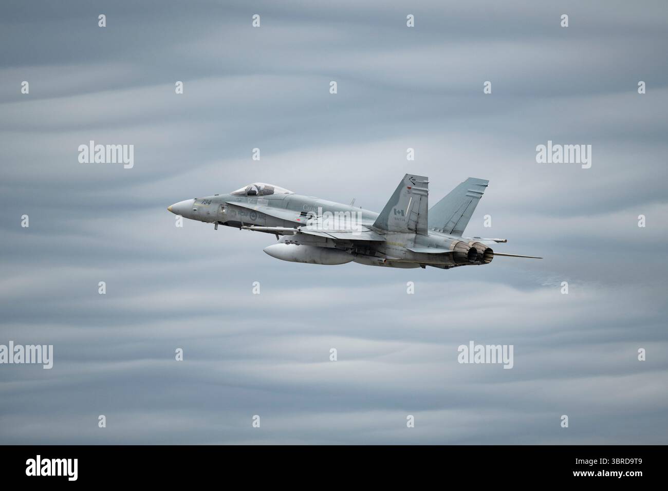 A North American Aerospace Defense Command CF-18 Hornet takes off for a training mission over Adak from Joint Base Elmendorf-Richardson, Alaska, July Stock Photo