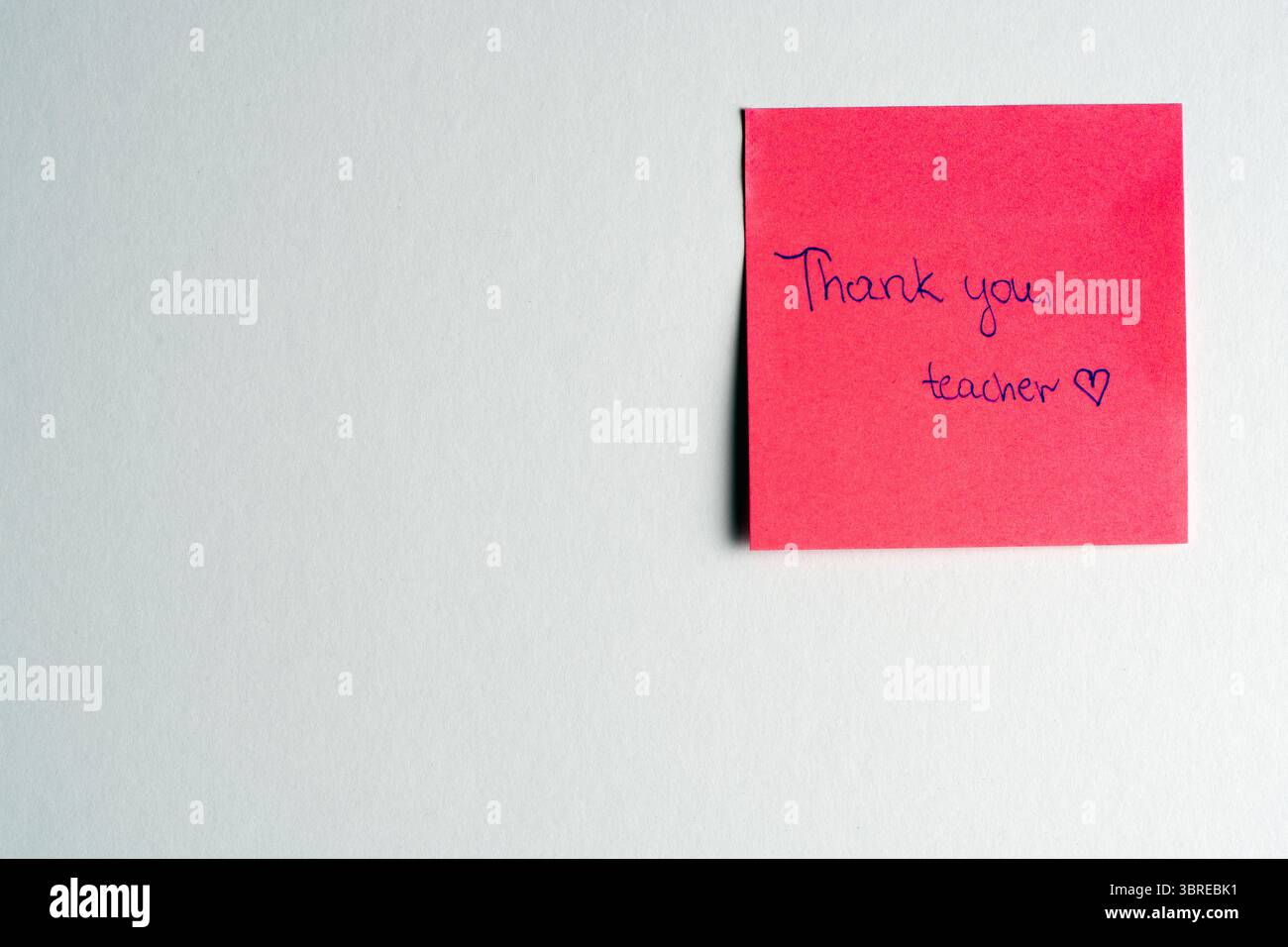 A vibrant red sticky note with