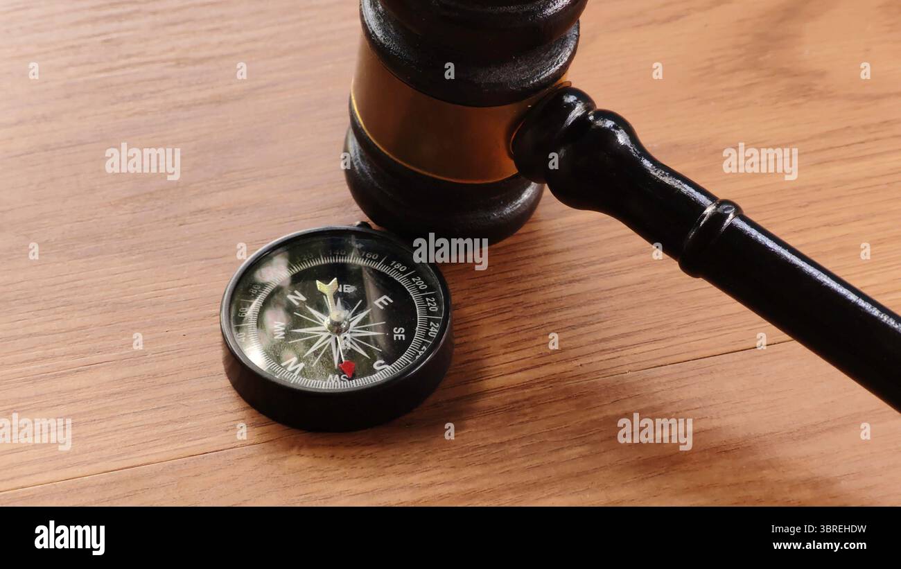 Gavel and Compass on Wooden Table Stock Photo