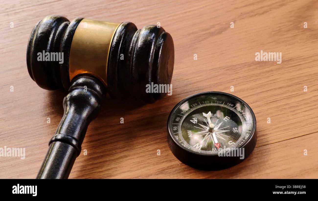 Gavel and Compass on Wooden Table Stock Photo
