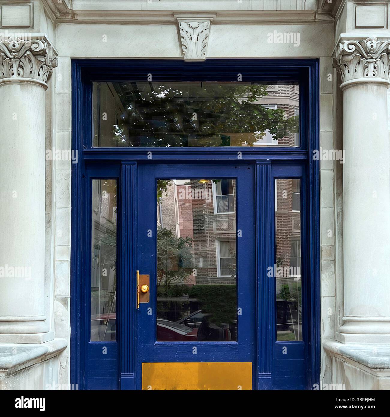 Royal blue door framed by fluted Corinthian columns and white stone detailing — a refined neoclassical entrance on a historic Chicago building. - Smartphone Captured Stock Image