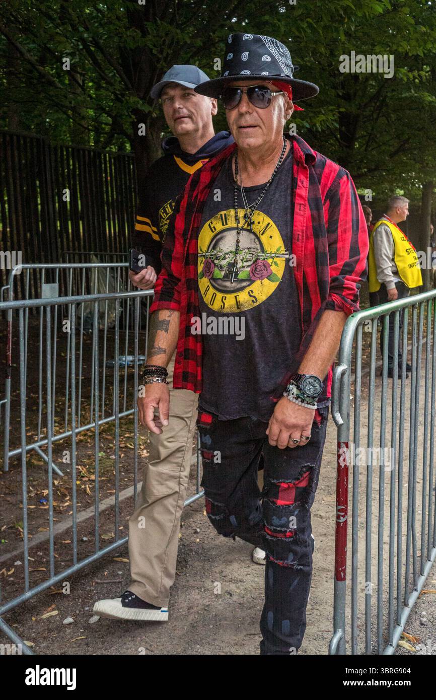 Warsaw, Poland. 12th July, 2025. A man in a plaid shirt and a Guns N ...