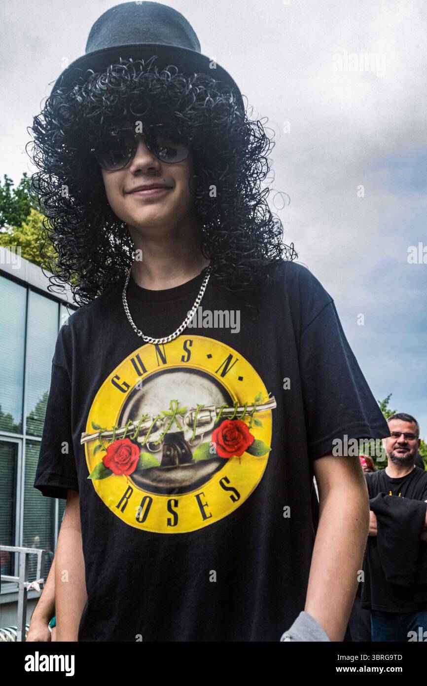 Warsaw, Poland. 12th July, 2025. A young Guns N' Roses fan queues for ...