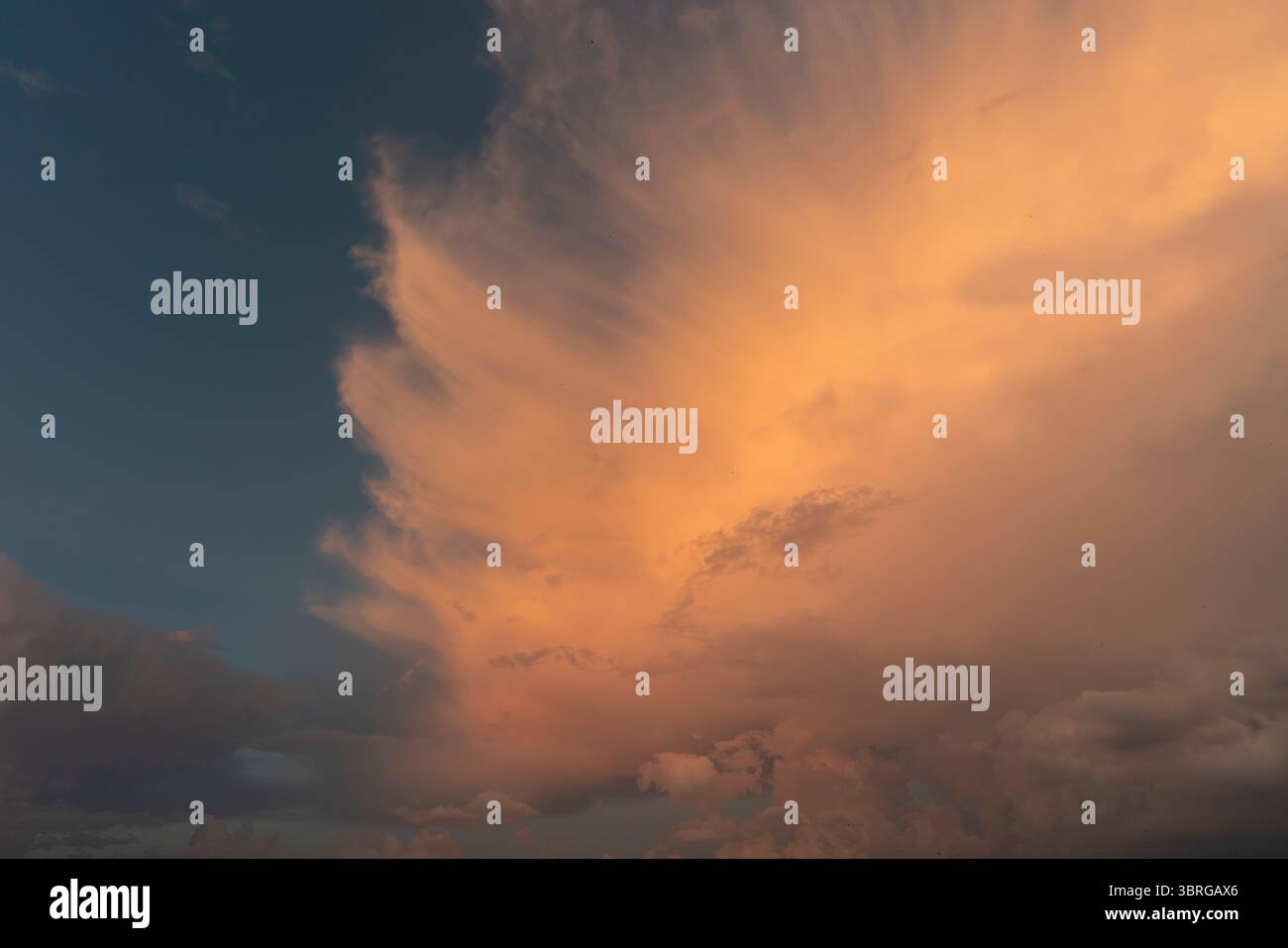 a beautiful picture of clouds, feathery clouds in the light of the setting sun, fluffy cloud against the blue sky Stock Photo