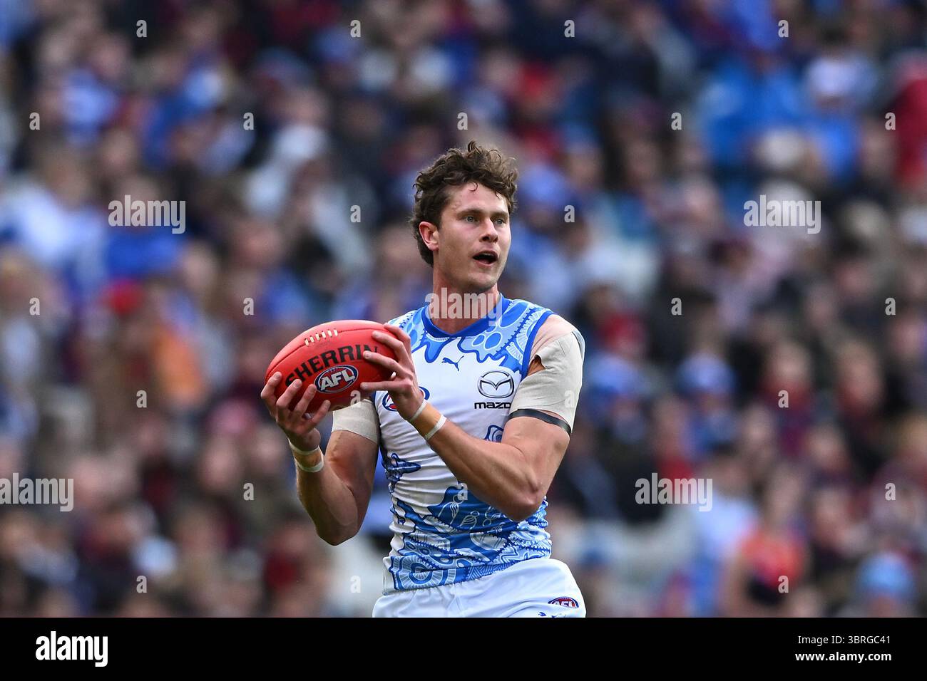 Comben Charlie Comben of North Melbourne marks the footy during the AFL Round ...