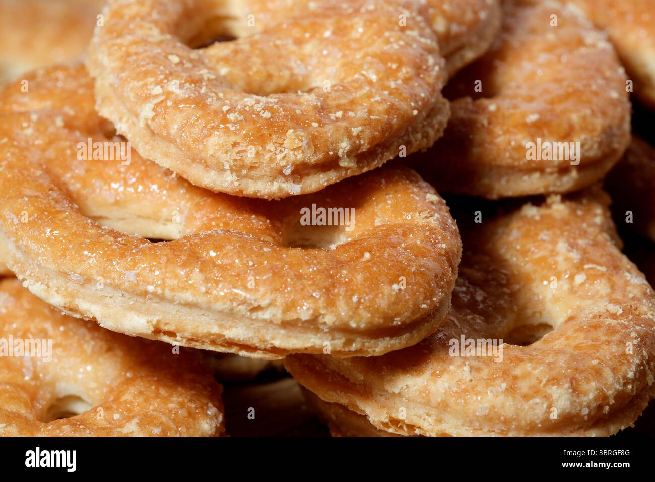 Sweet, golden pastries glisten with sugar, inviting all to indulge. Stock Photo