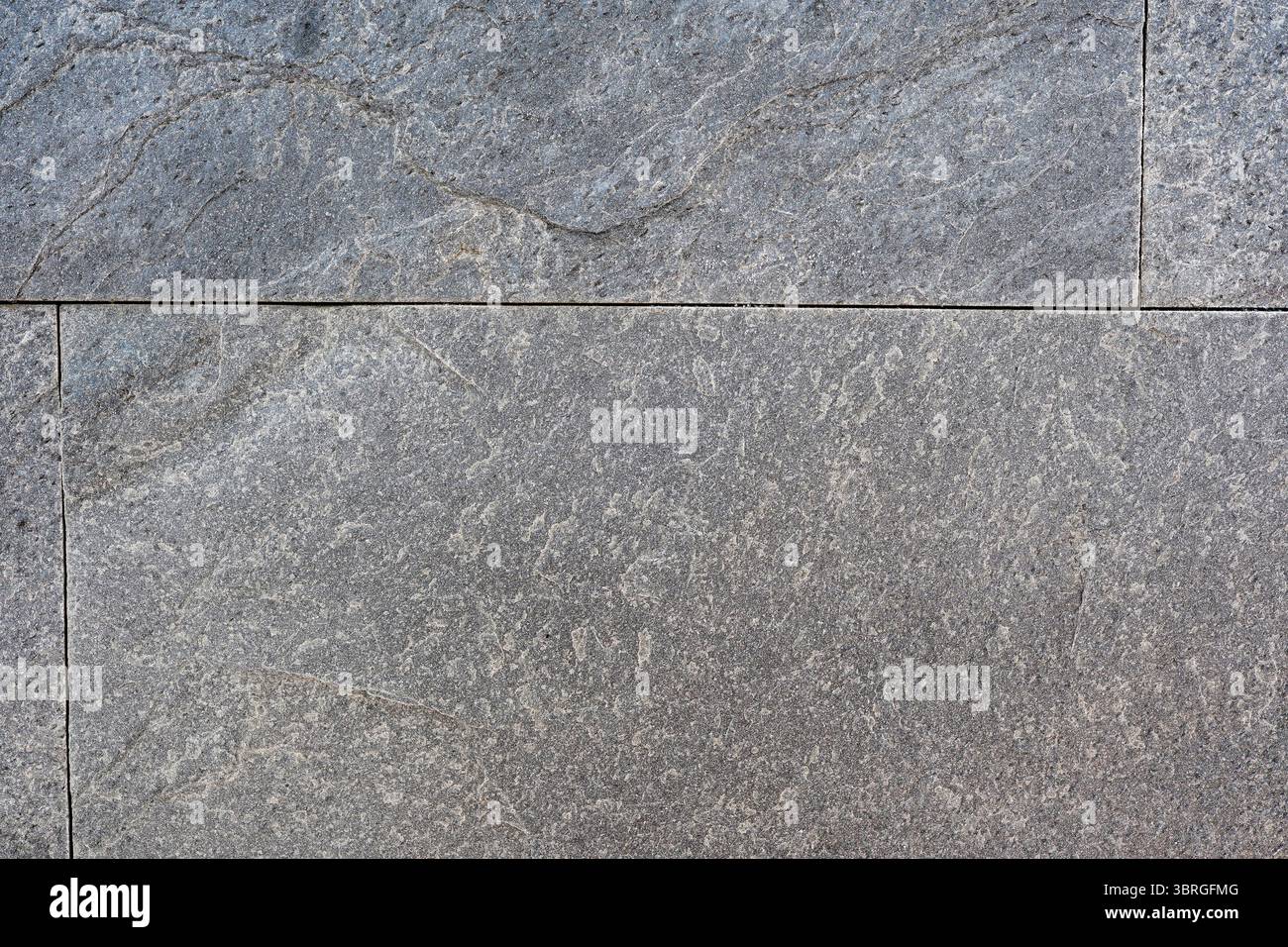 Subtle gray stone surface features intricate patterns and textures. Stock Photo