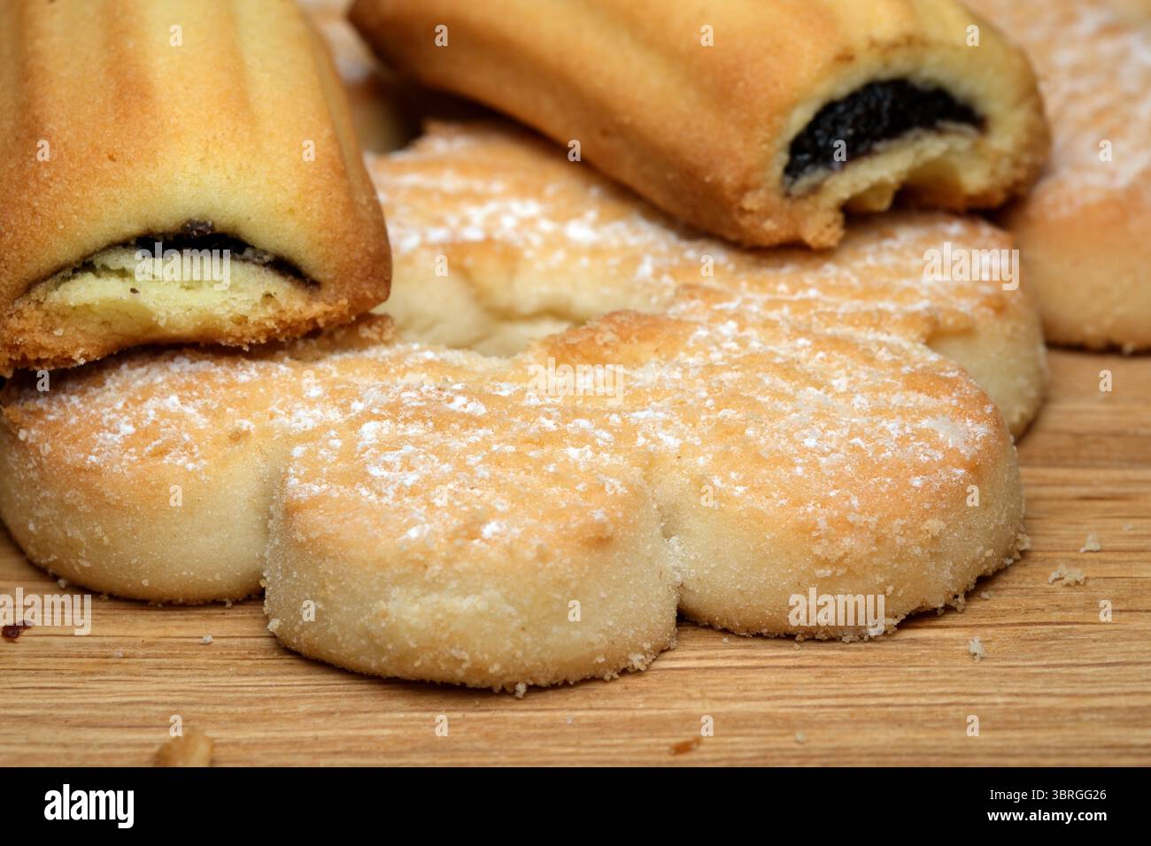 A batch of freshly baked cookies rests on a rustic wooden surface, showcasing a variety of textures and flavors. Sweet aromas fill the air, inviting i Stock Photo