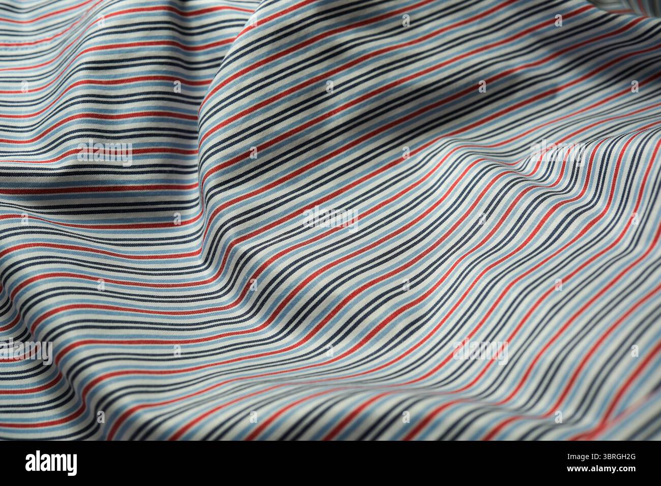 Bold lines of varying colors flow smoothly across textured fabric Stock ...