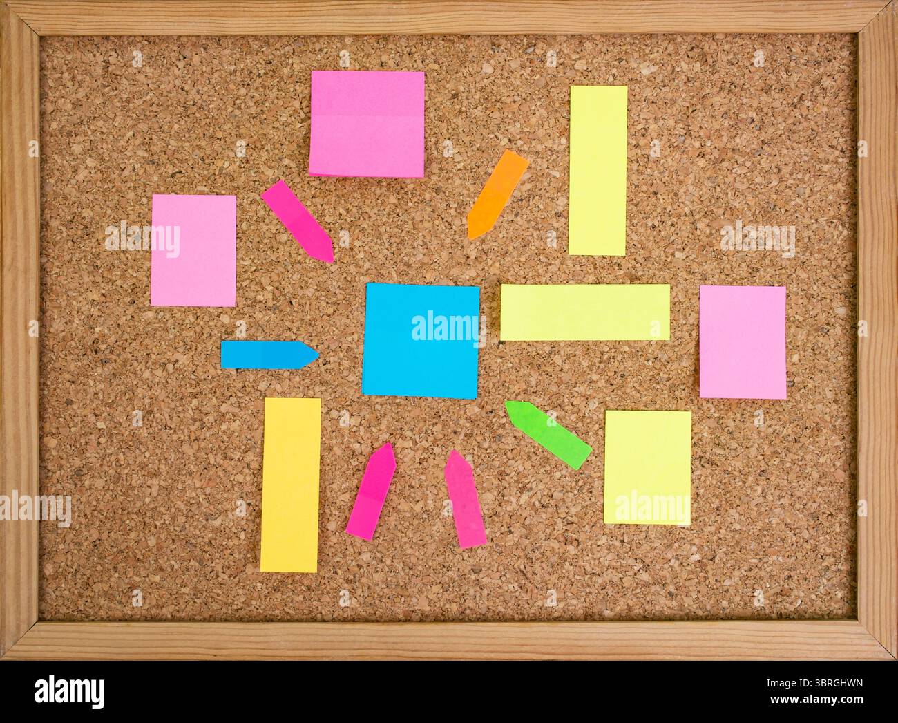 Multiple colorful paper posts, empty backdrop on cork board background, brainstorming Stock Photo