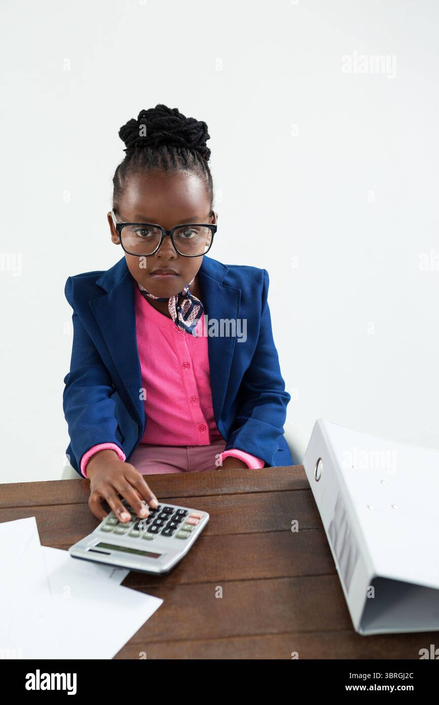 Portrait of businesswoman using calculator Stock Photo