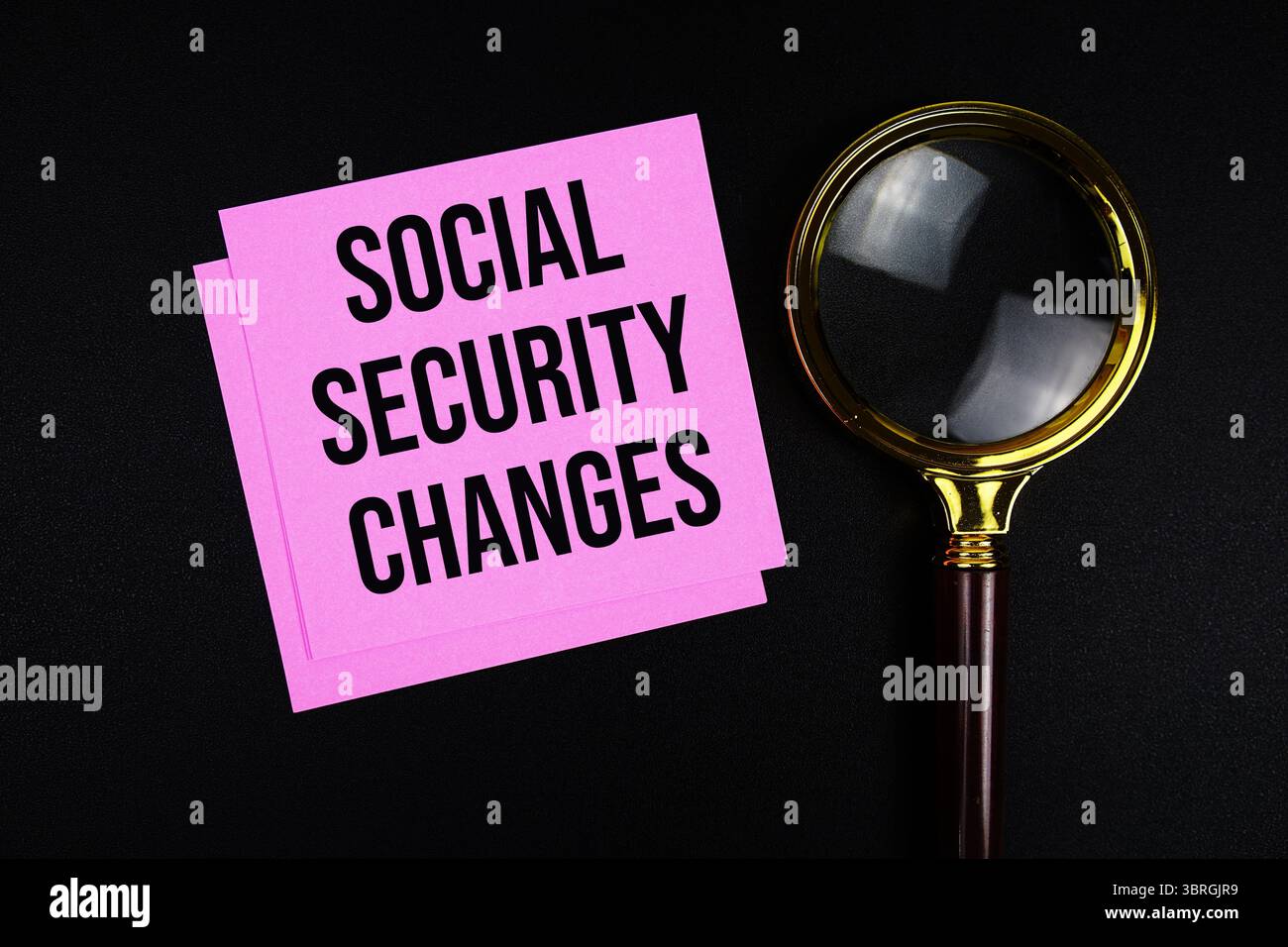 Social Security Changes text on sticky note with magnifying glass on black background Stock Photo