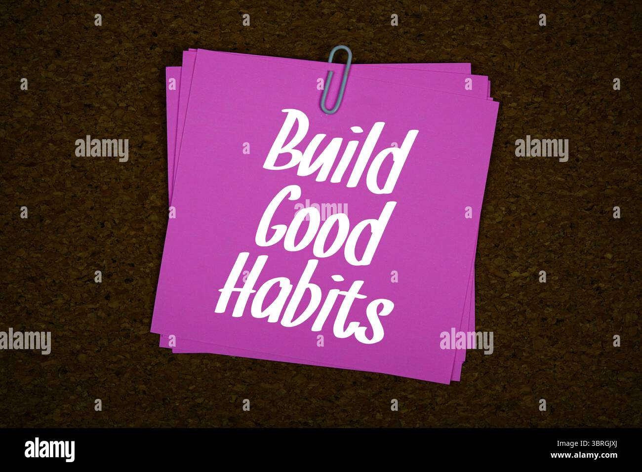 Build Good Habits text message on stick note on cork paper background ...