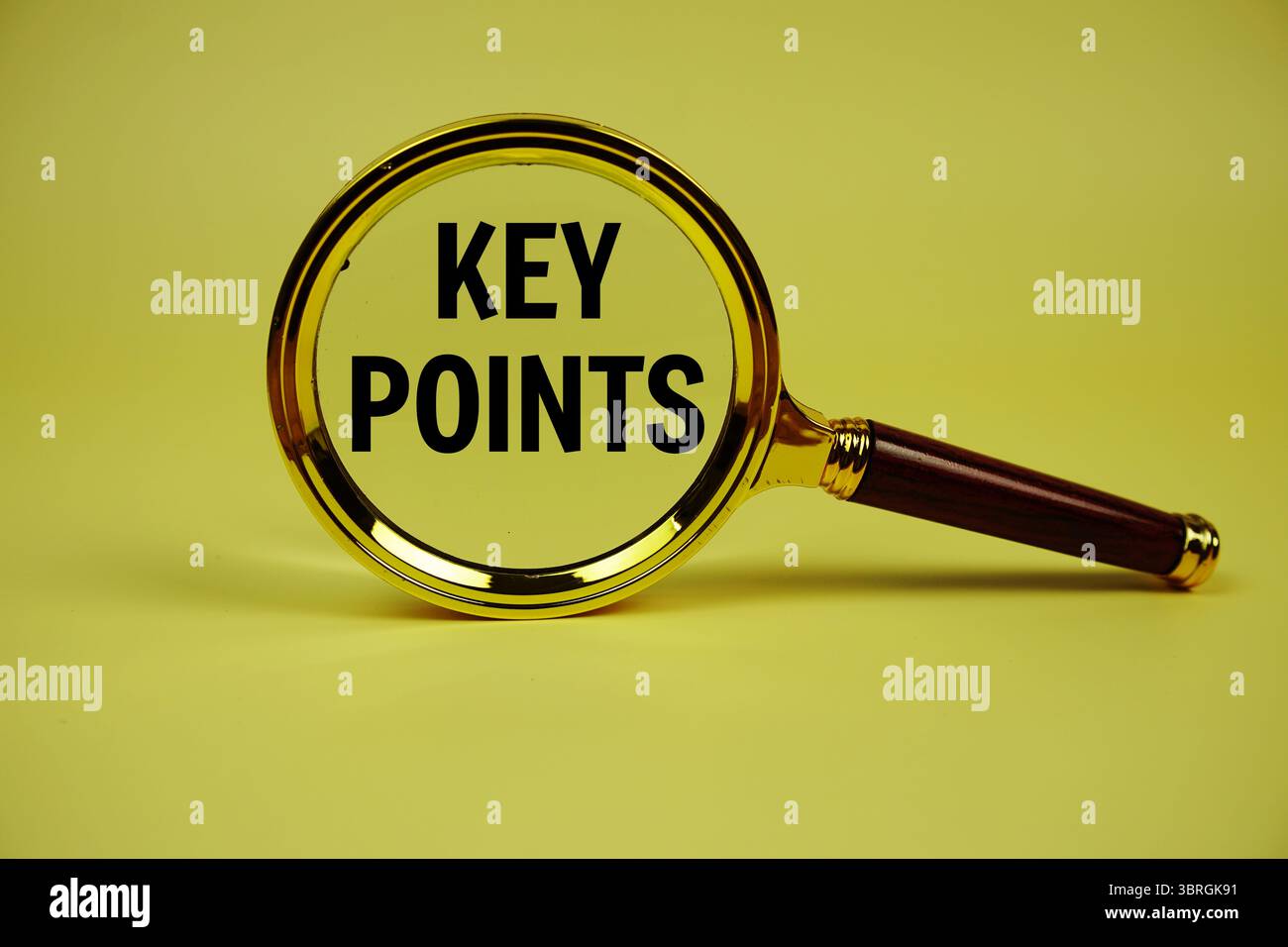 Key Points text with magnifying glass on yellow background Stock Photo