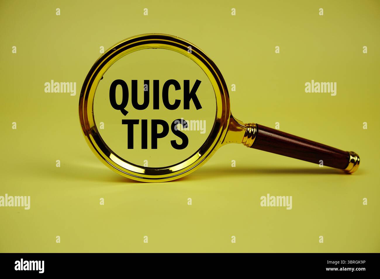 Quick Tips text with magnifying glass on yellow background Stock Photo ...