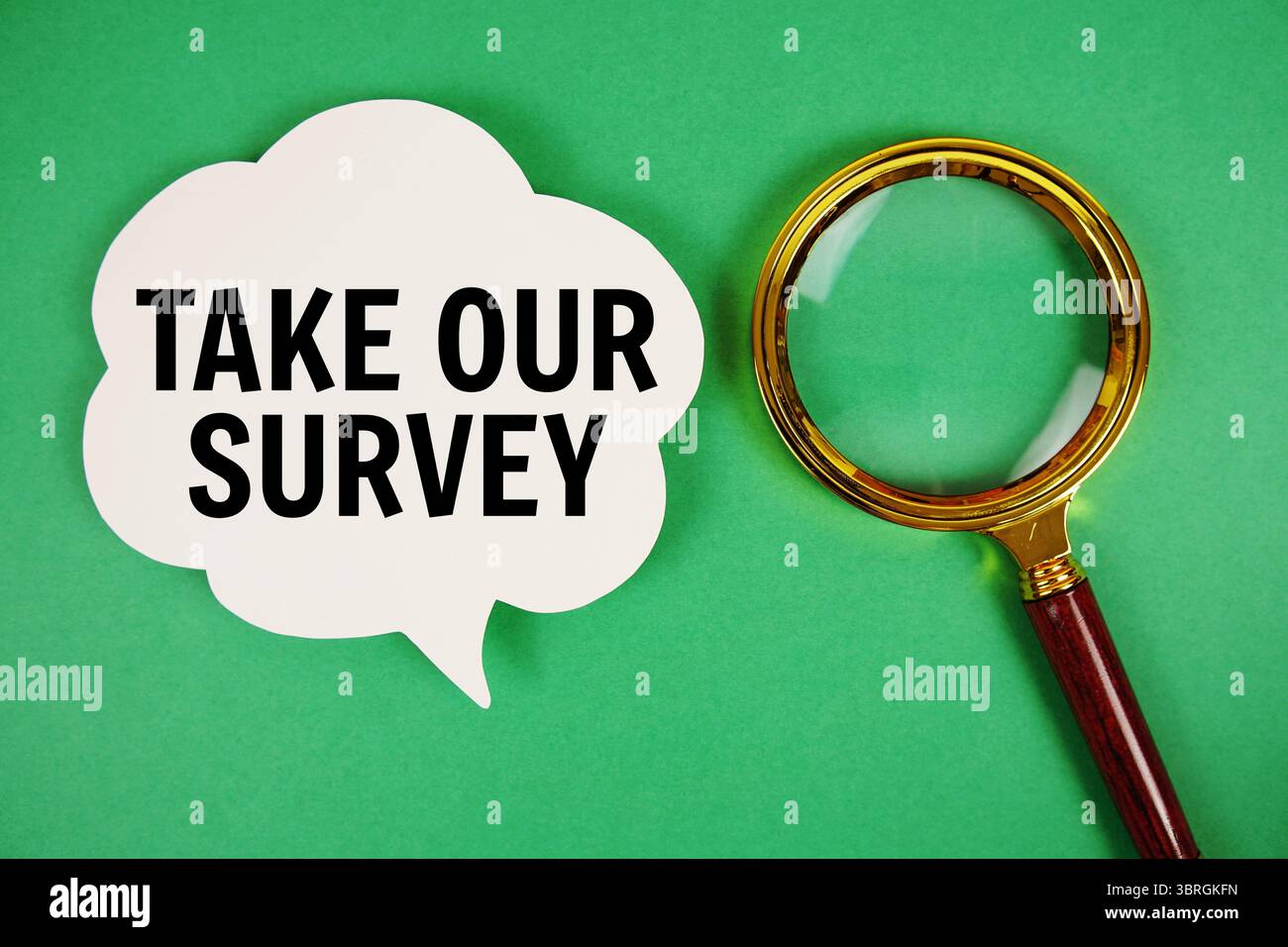 Take Our Survey text with speech bubble and magnifying glass on green background Stock Photo