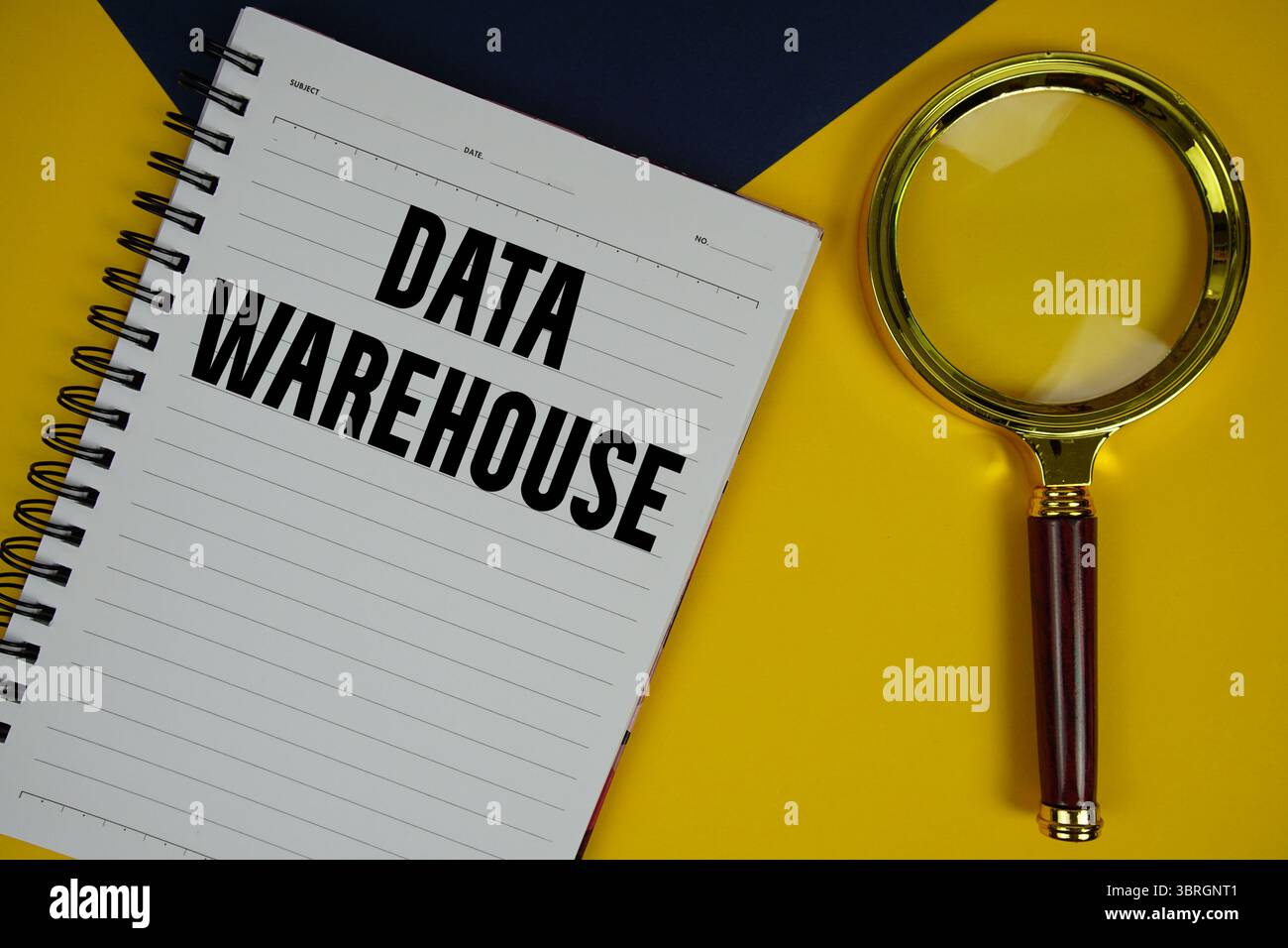 Data Warehouse text with magnifying glass on yellow background Stock Photo