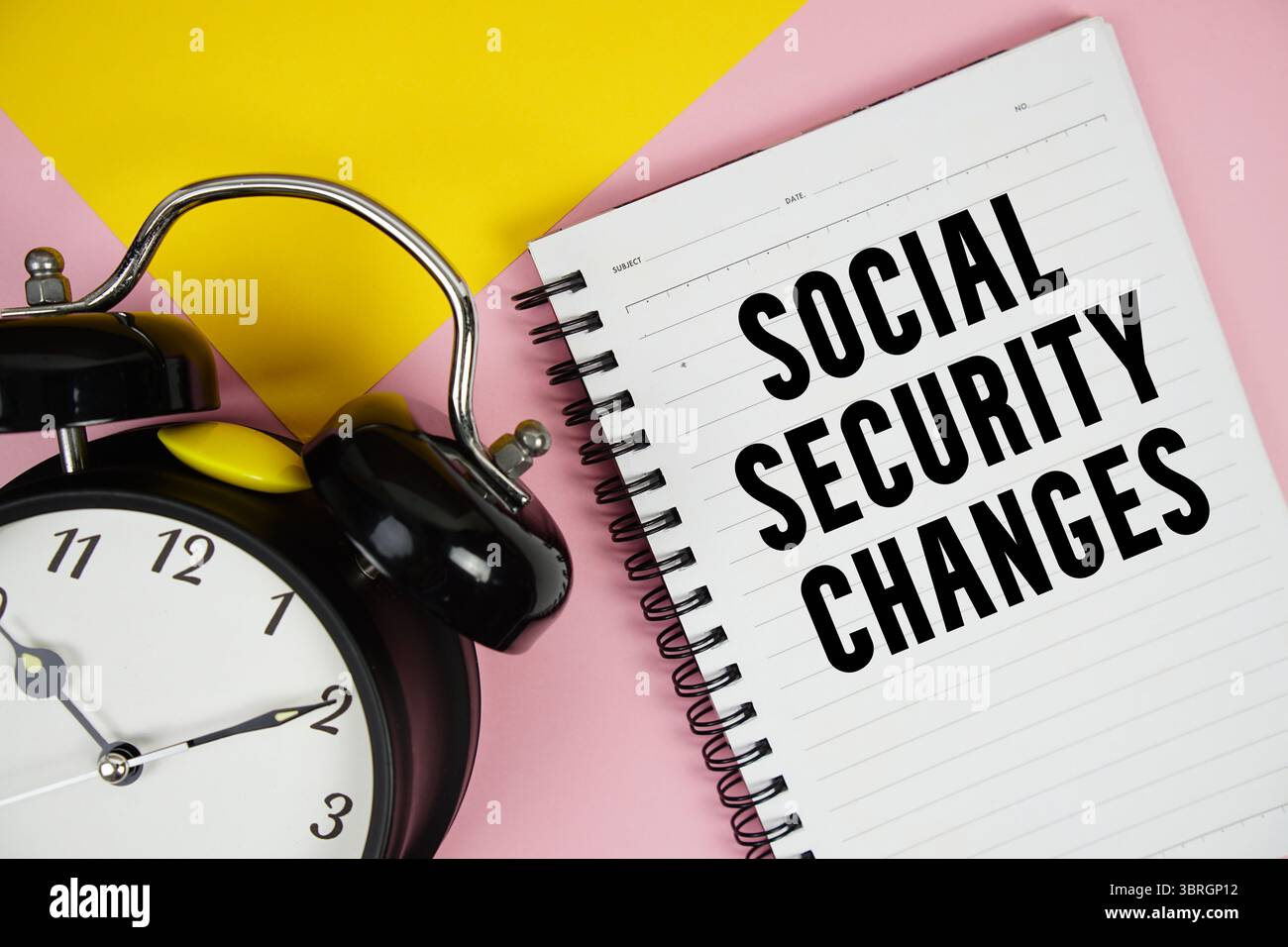 Social Security Changes text written on notepad with alarm clock on pink background Stock Photo