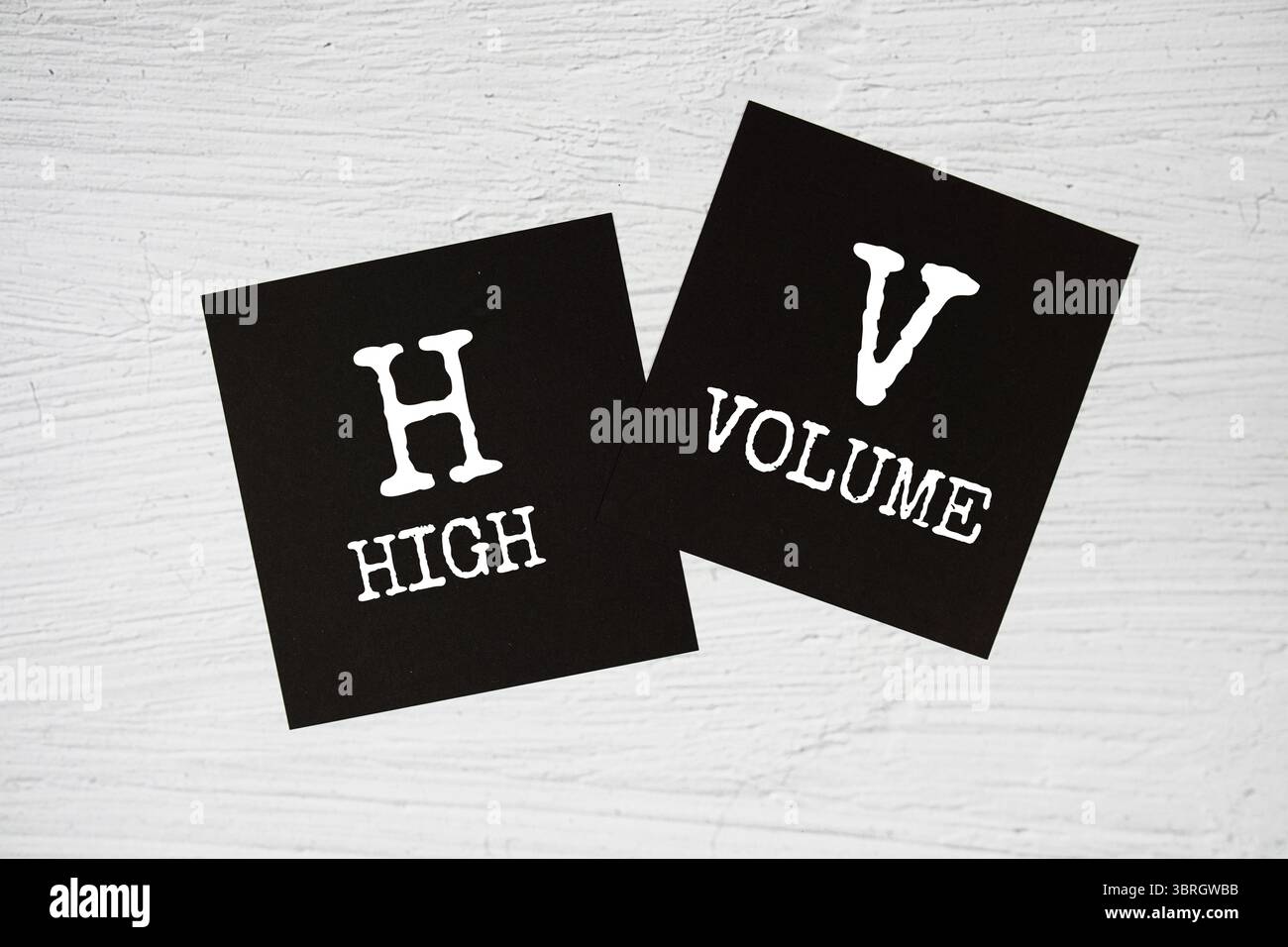HV - High Volume text on stick note on concrete background Stock Photo