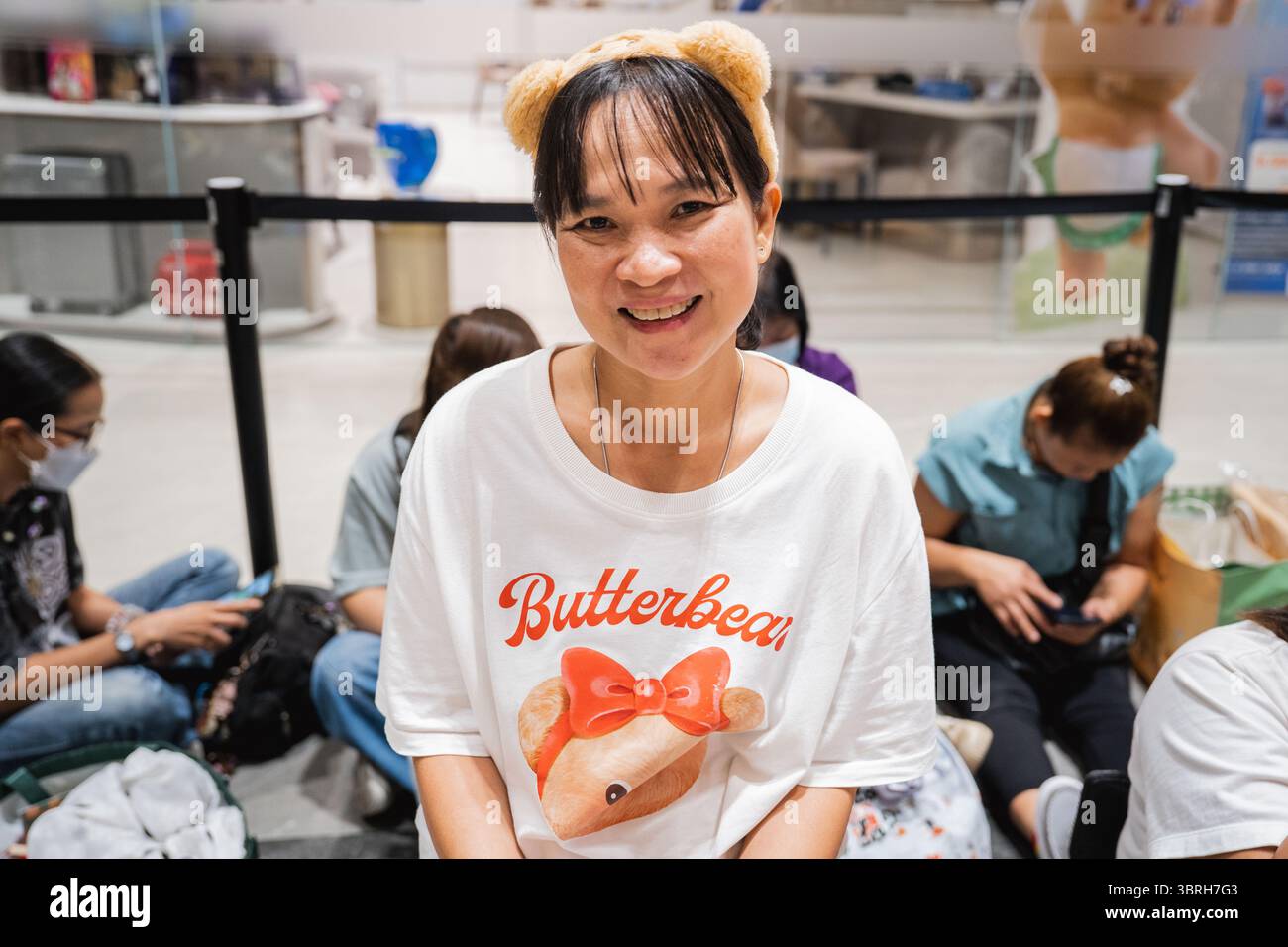 A woman wears a Butterbear T-shirt and matching ears at Buttery World ...